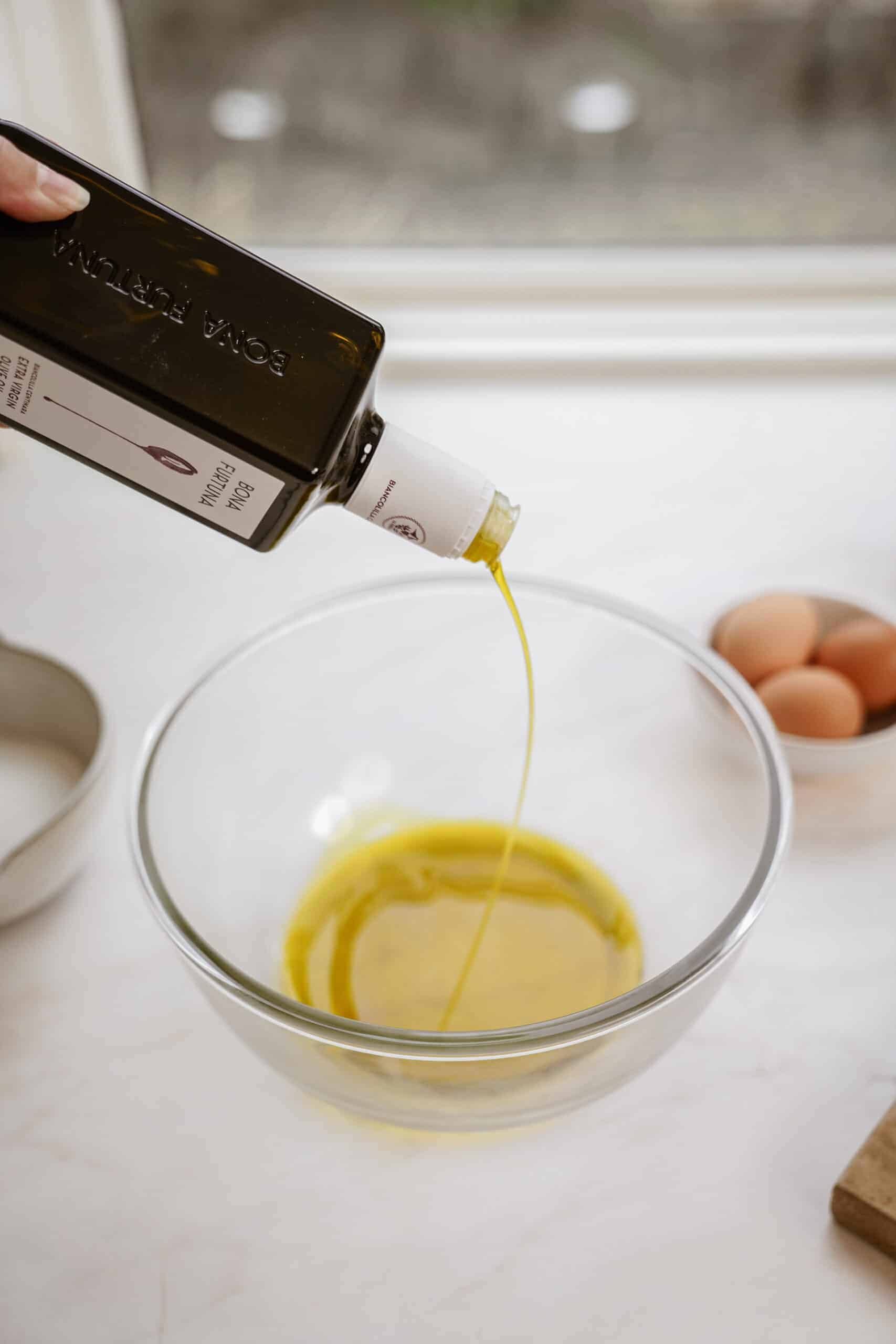 Olive oil being poured into a bowl