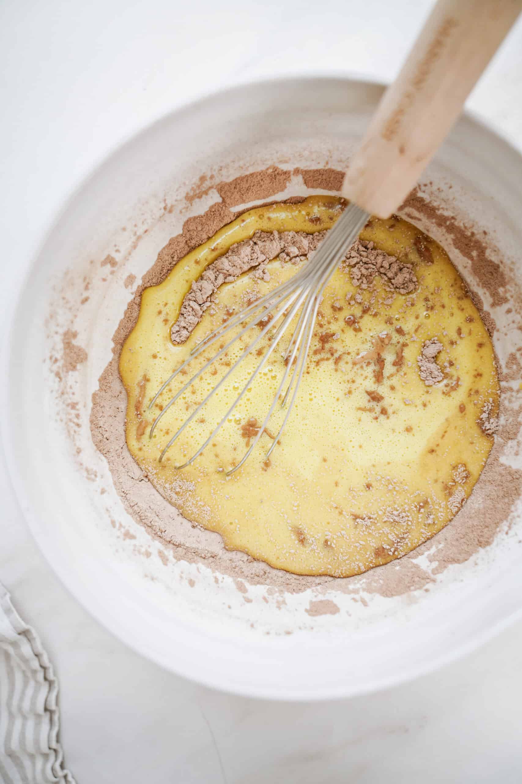 Ingredients being mixed in a bowl with a whisk