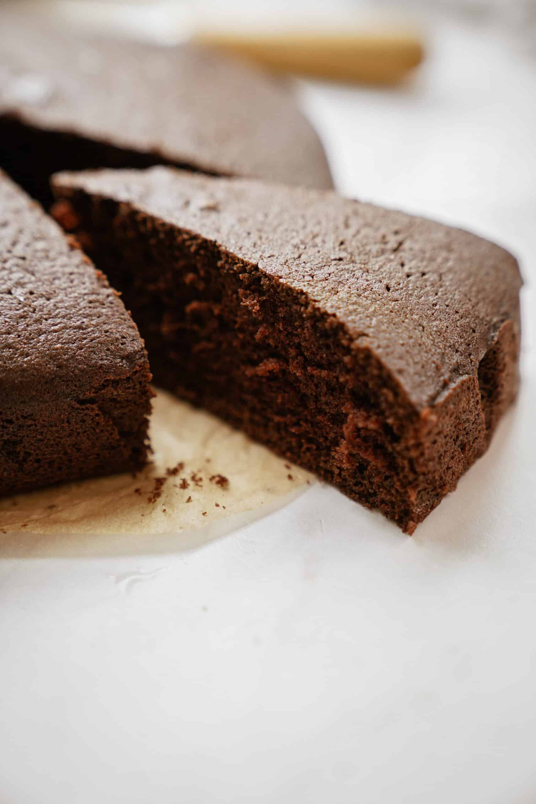 Slice of chocolate olive oil cake cut out of a cake