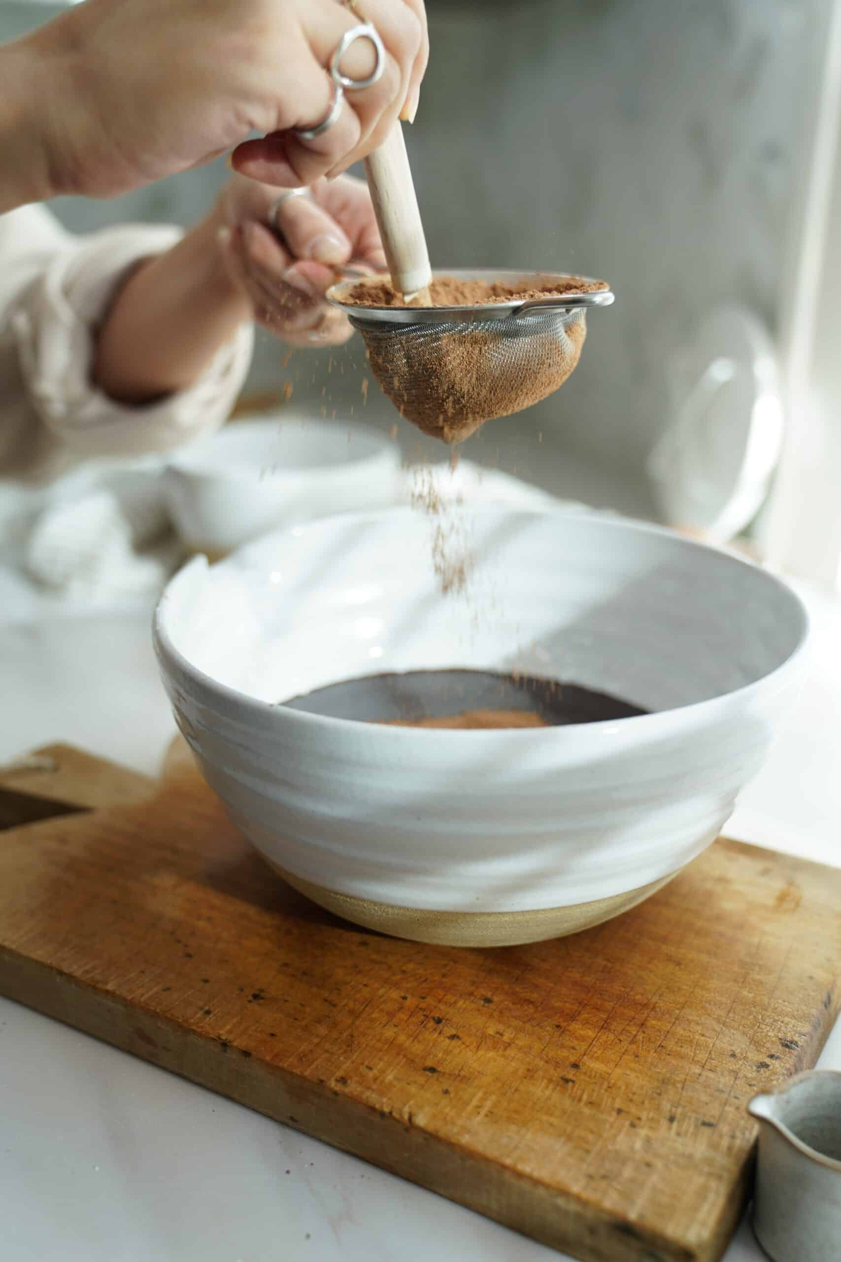 Sifting powder over chocolate