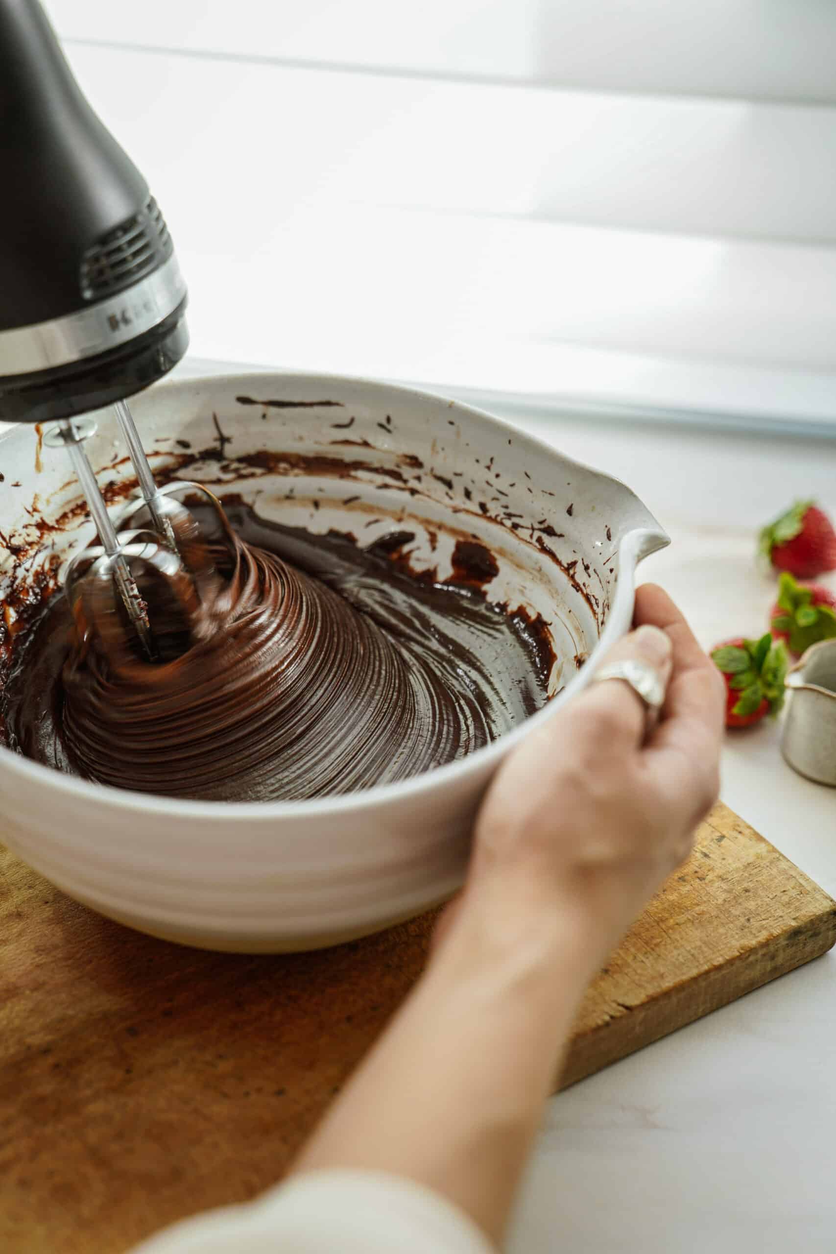 Ingredients for gluten-free chocolate cupcakes being mixed in a mixing bowl