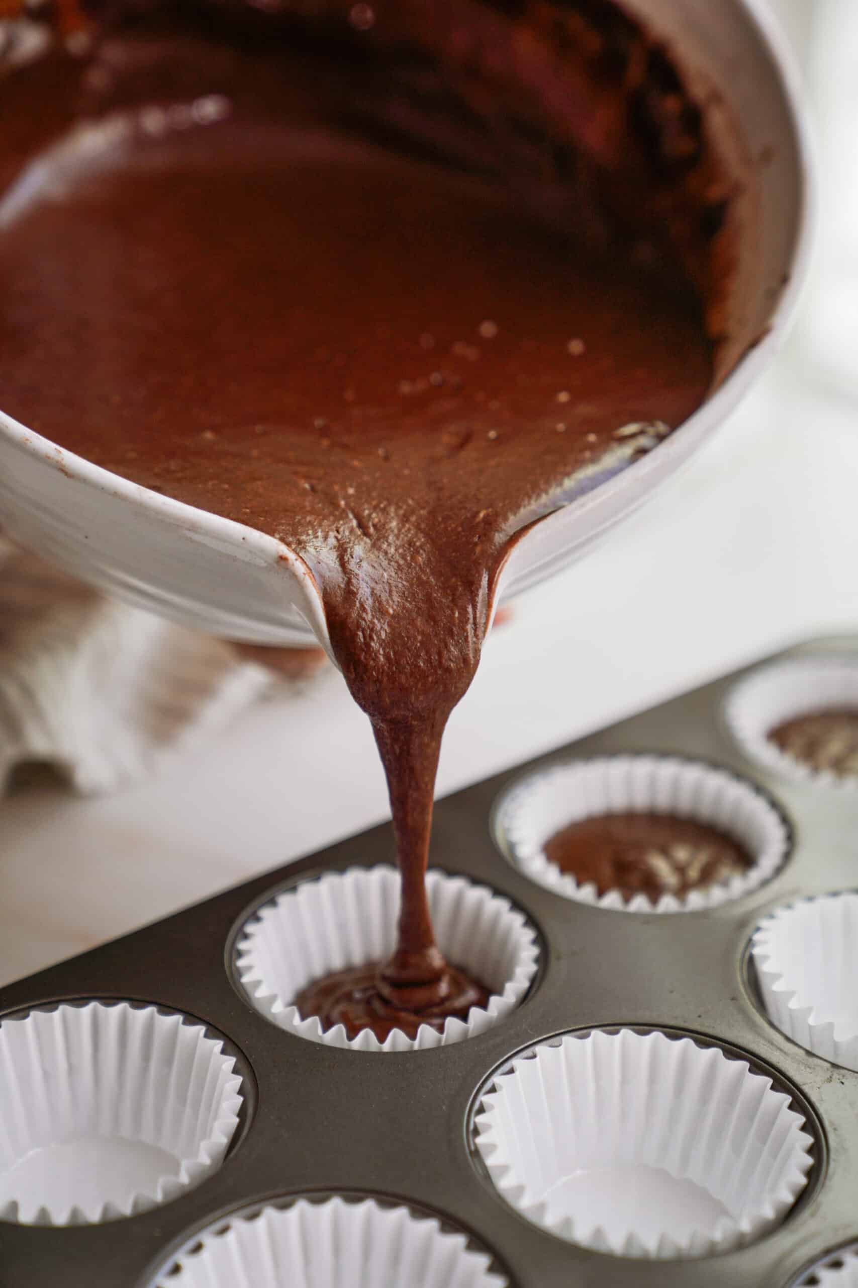 Cupcake batter being added into muffin tin