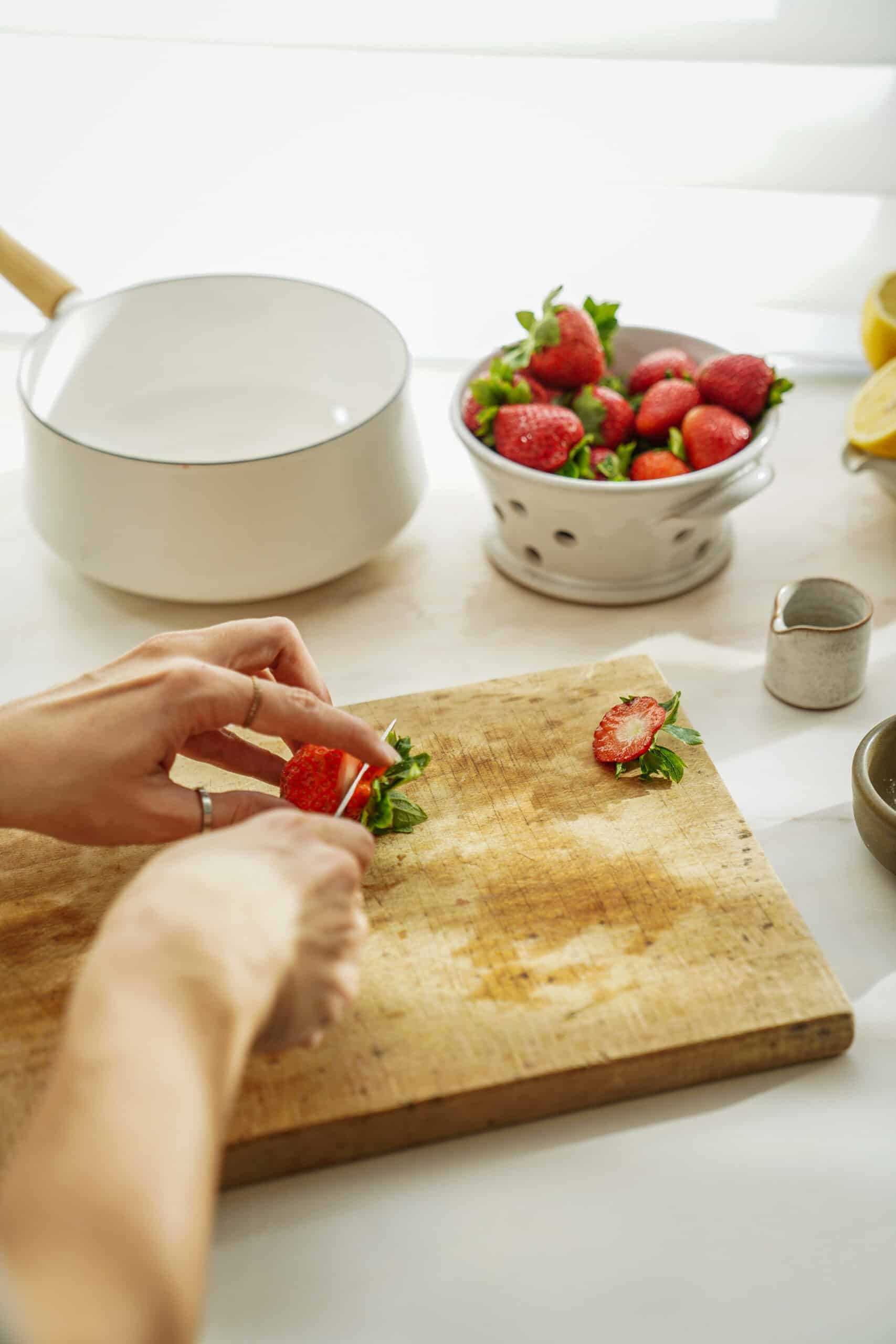 Cutting strawberries for cupcake filling