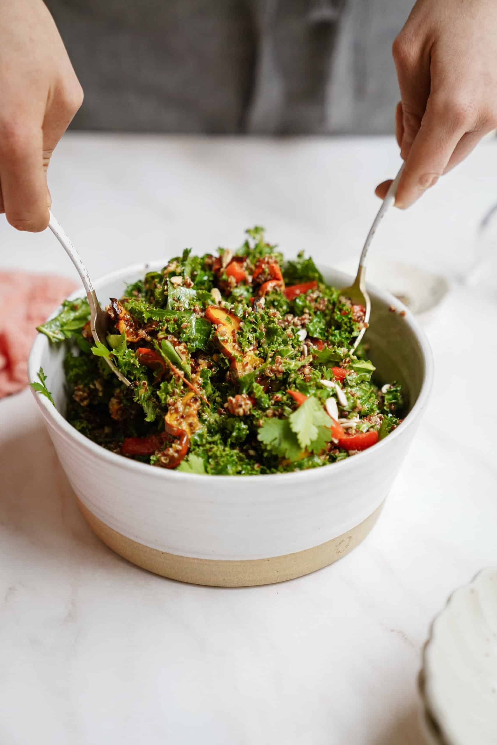 Kale Quinoa Salad being scooped with 2 spoons