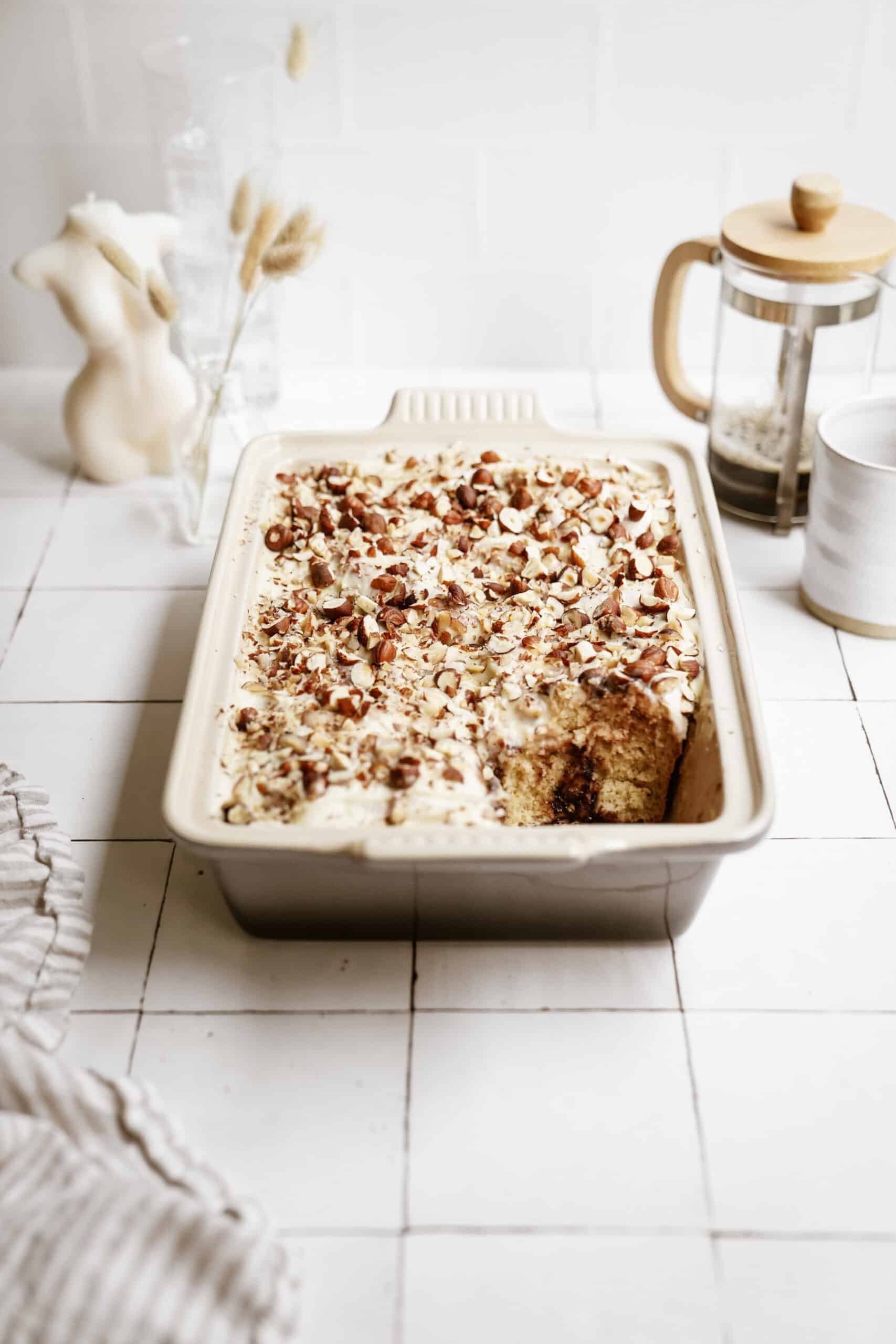 Nutella cinnamon rolls in a casserole dish with nuts on top