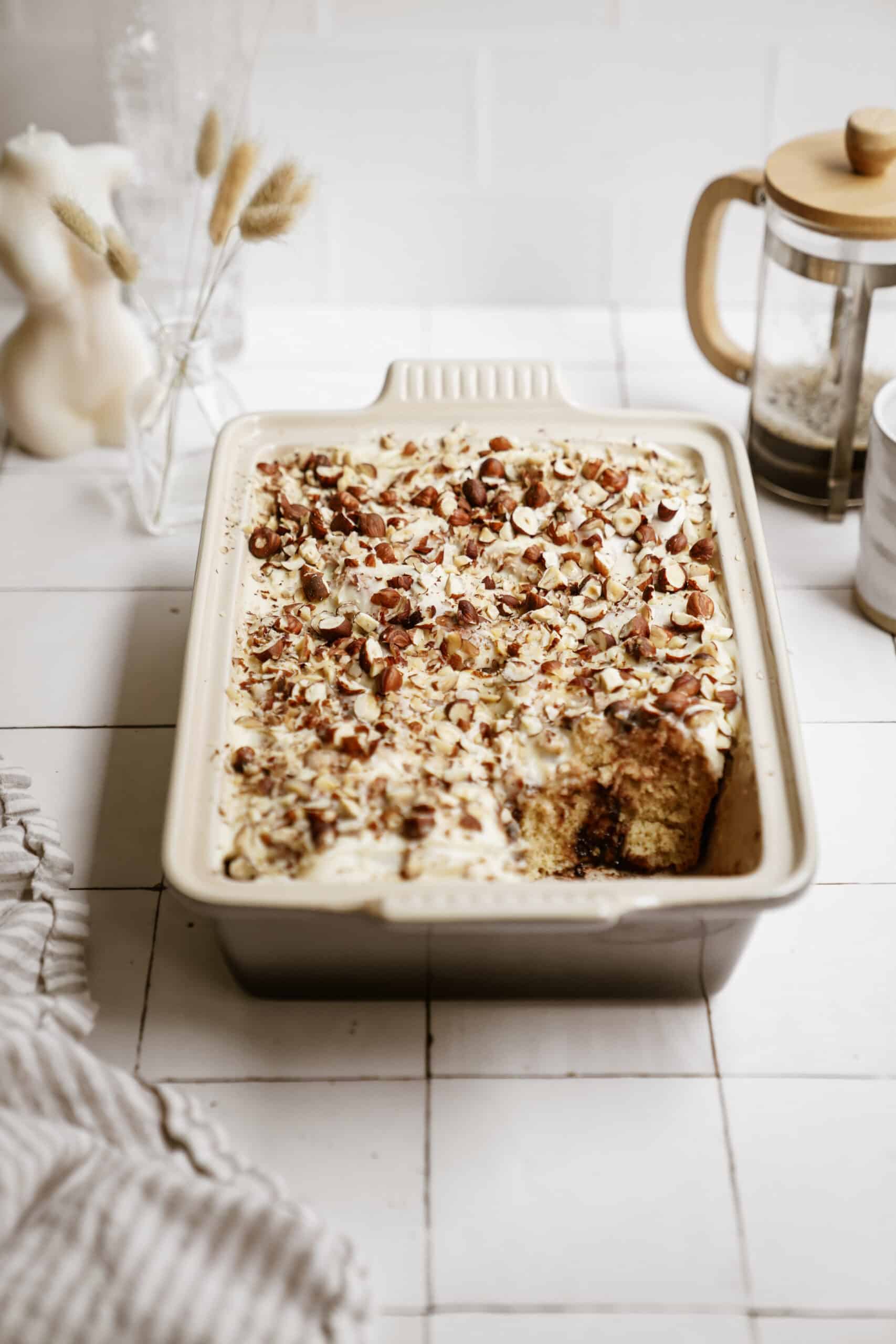 Nutella cinnamon rolls in a casserole dish with nuts on top