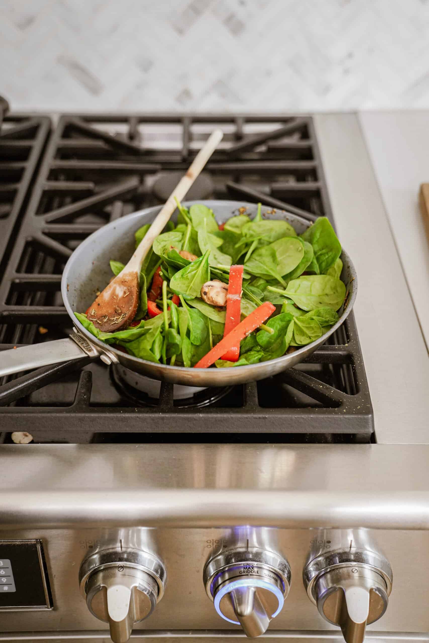 Fresh spinach and veggies for vegetarian breakfast burrito