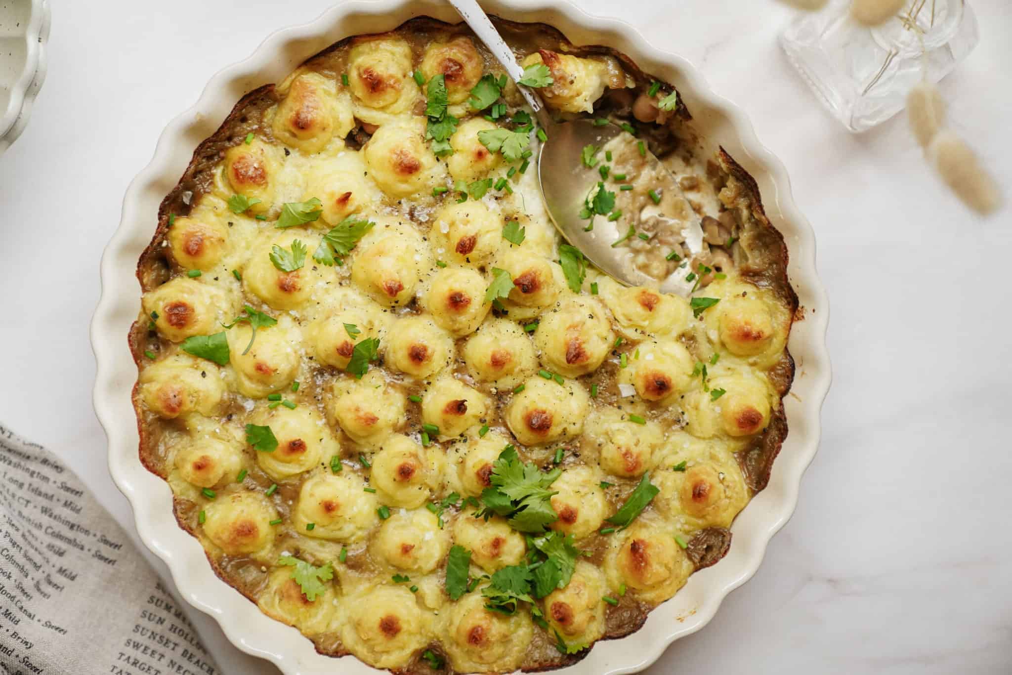 White Bean Shepherd's Pie in a casserole dish with a spoon
