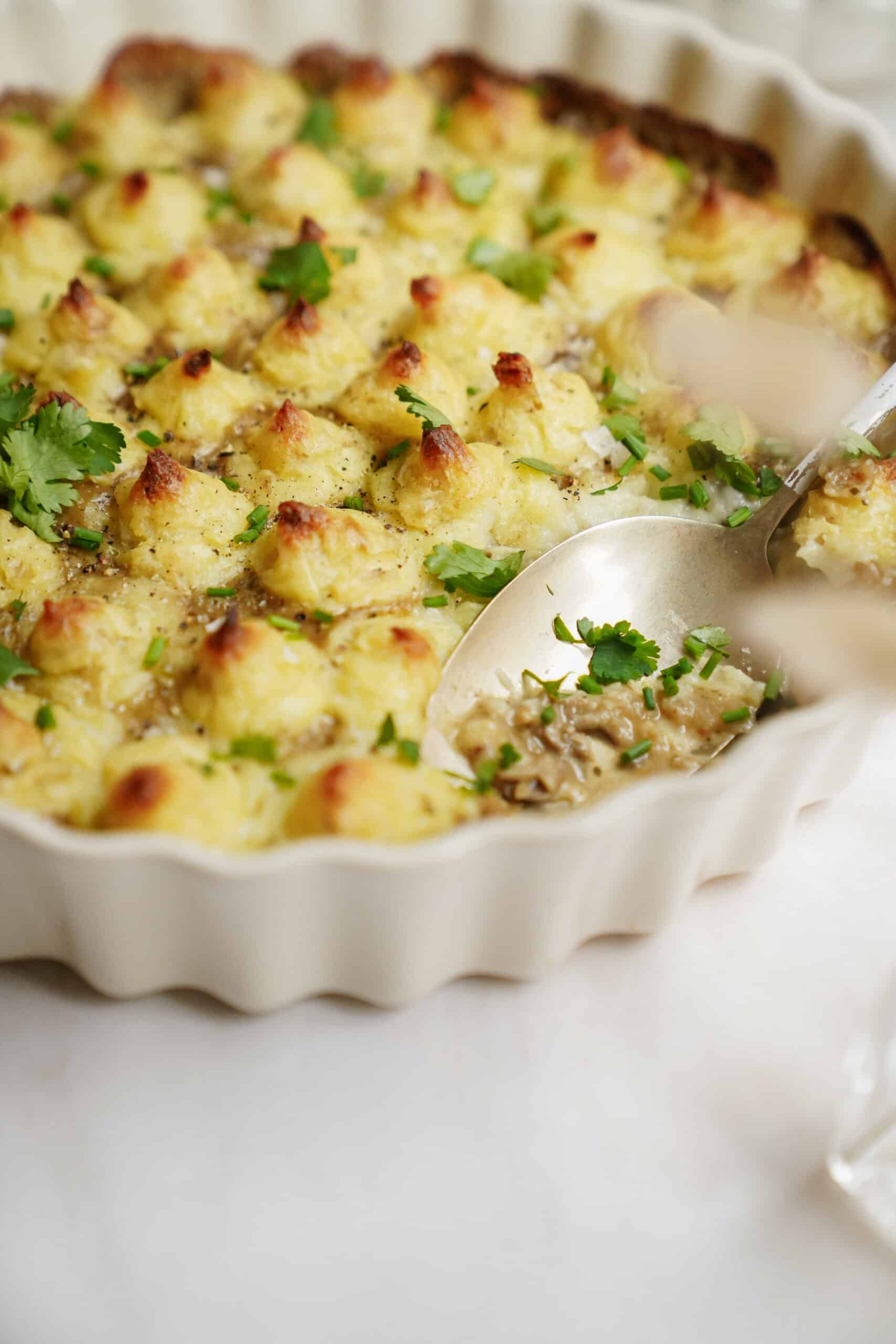 White Bean Shepherd's Pie in a casserole dish with a spoon