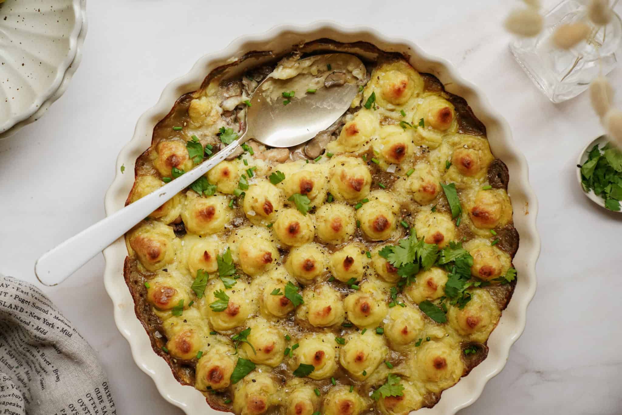 White Bean Shepherd's Pie in a casserole dish with a spoon