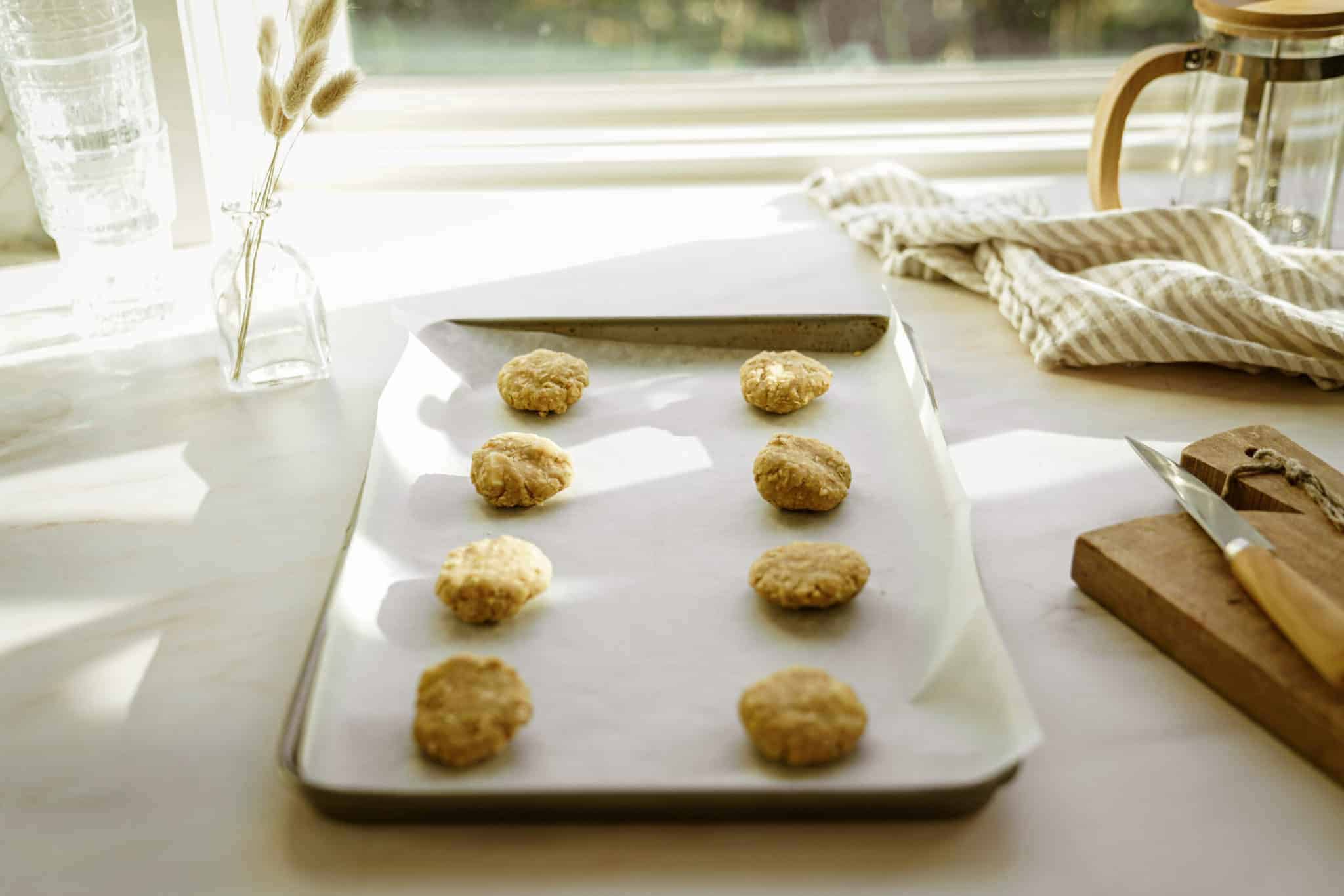 Rolled White Chocolate Oatmeal Cookies on a baking tray ready to cook