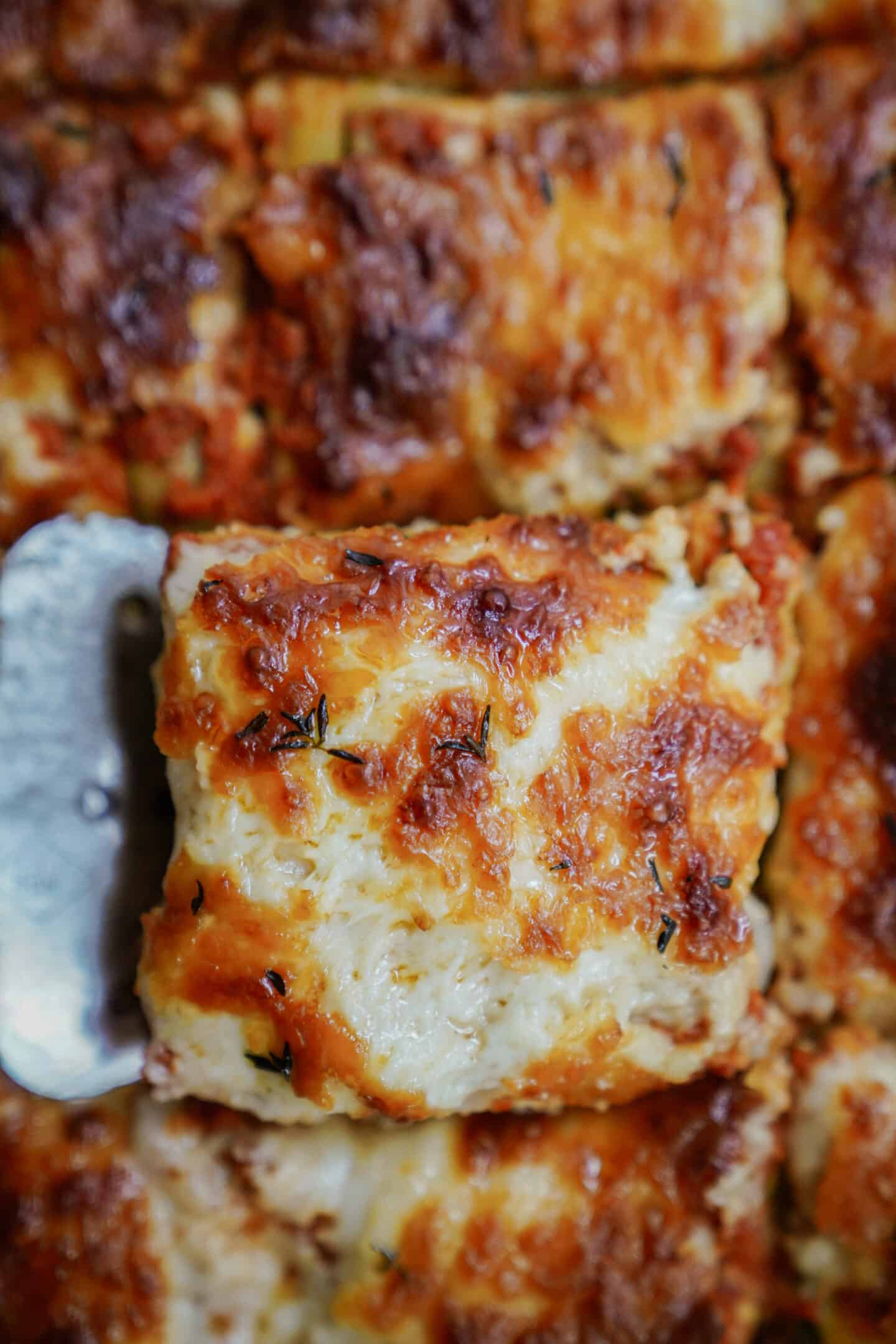 Slice of zucchini lasagna recipe being picked up with a spatula