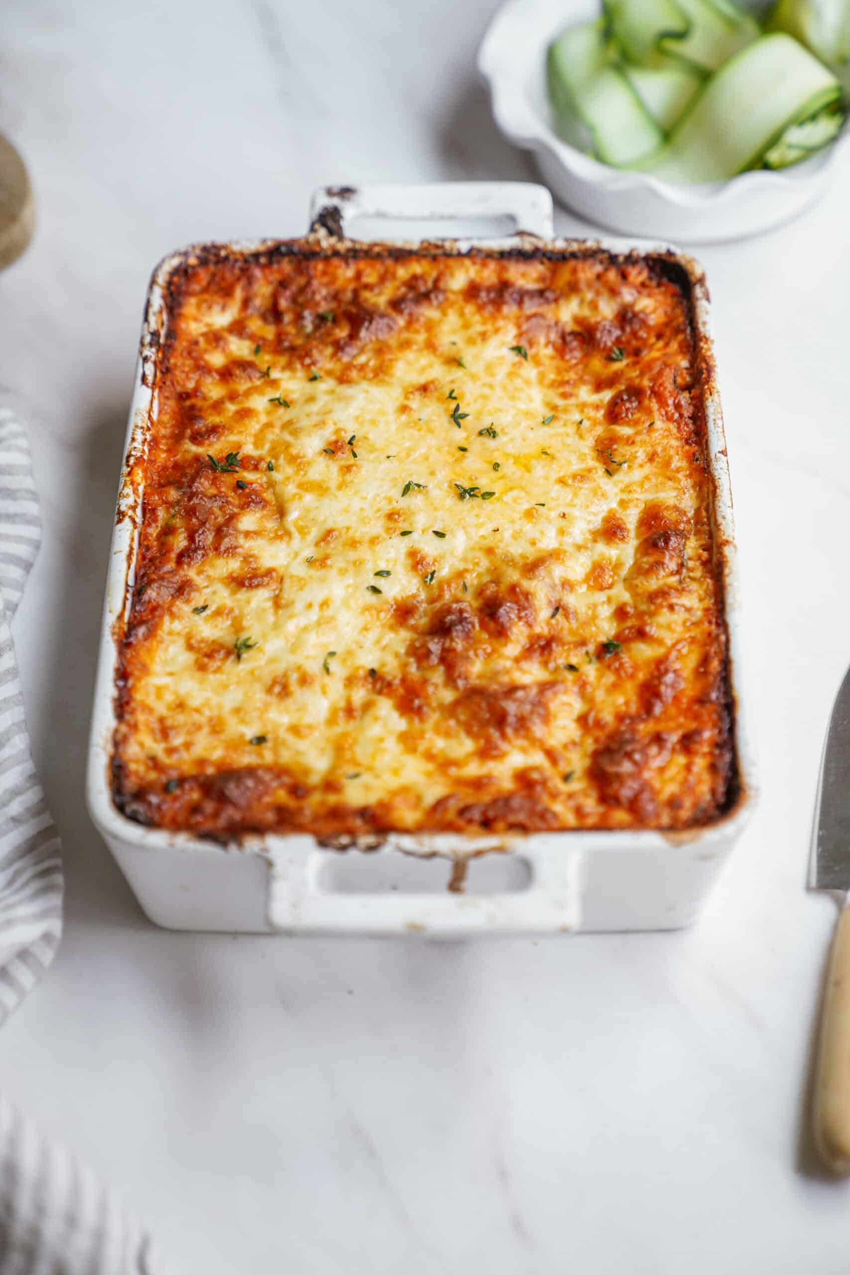 Zucchini lasagna recipe in a casserole dish on a counter