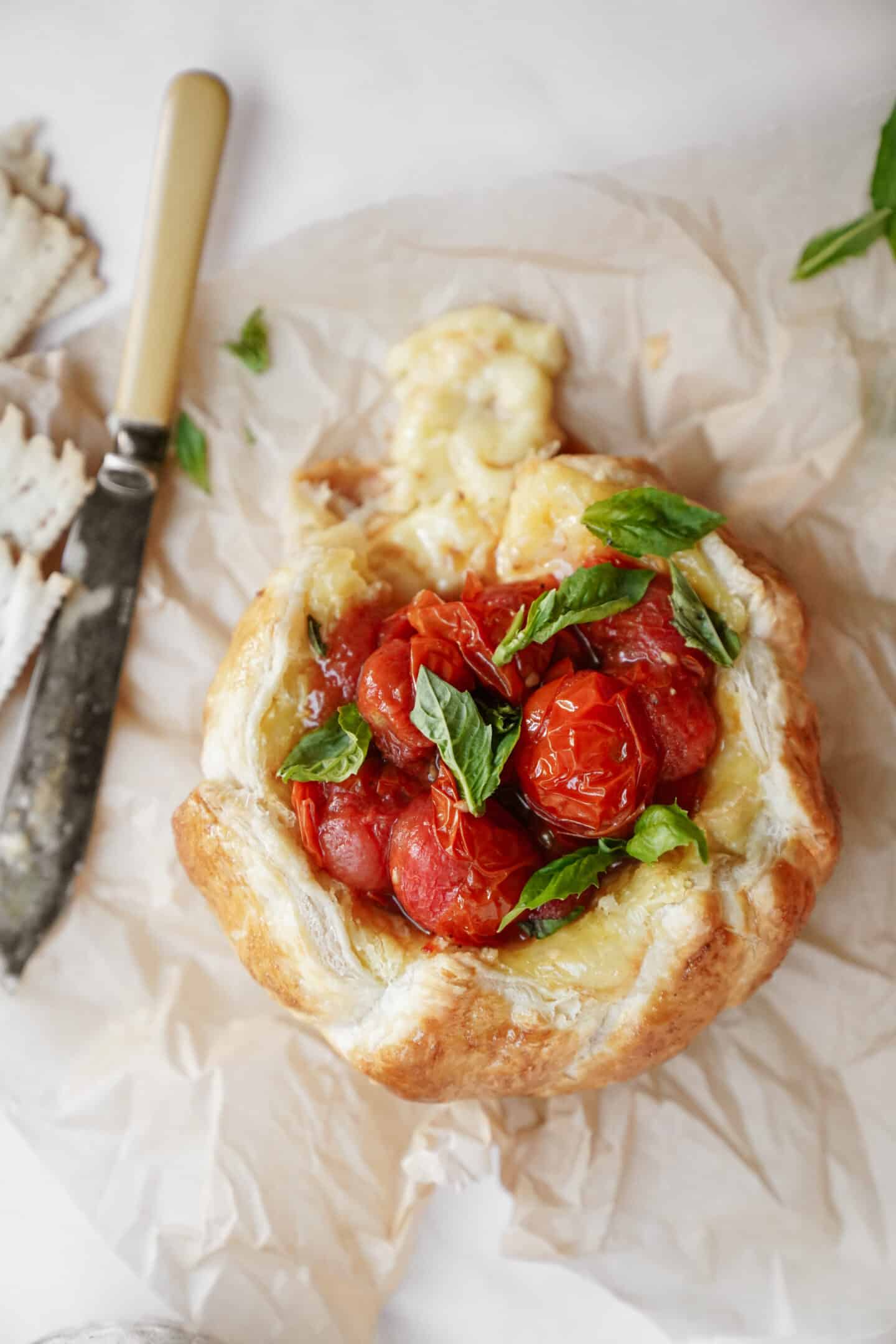 Baked brie on a counter next to a knife