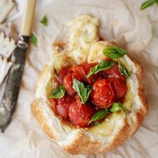 Baked brie on a counter next to a knife