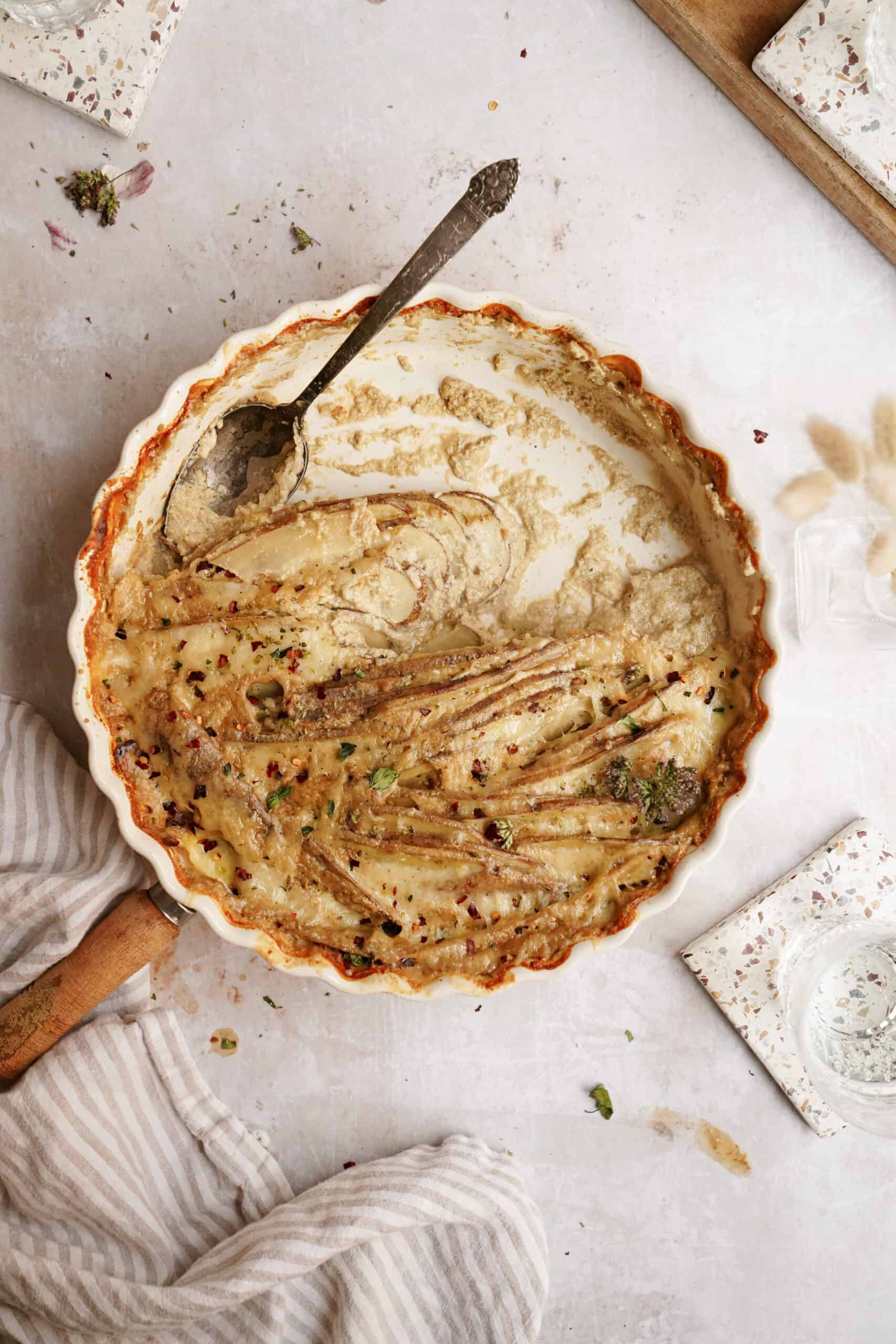 The best scalloped potatoes recipe in a casserole dish on a counter