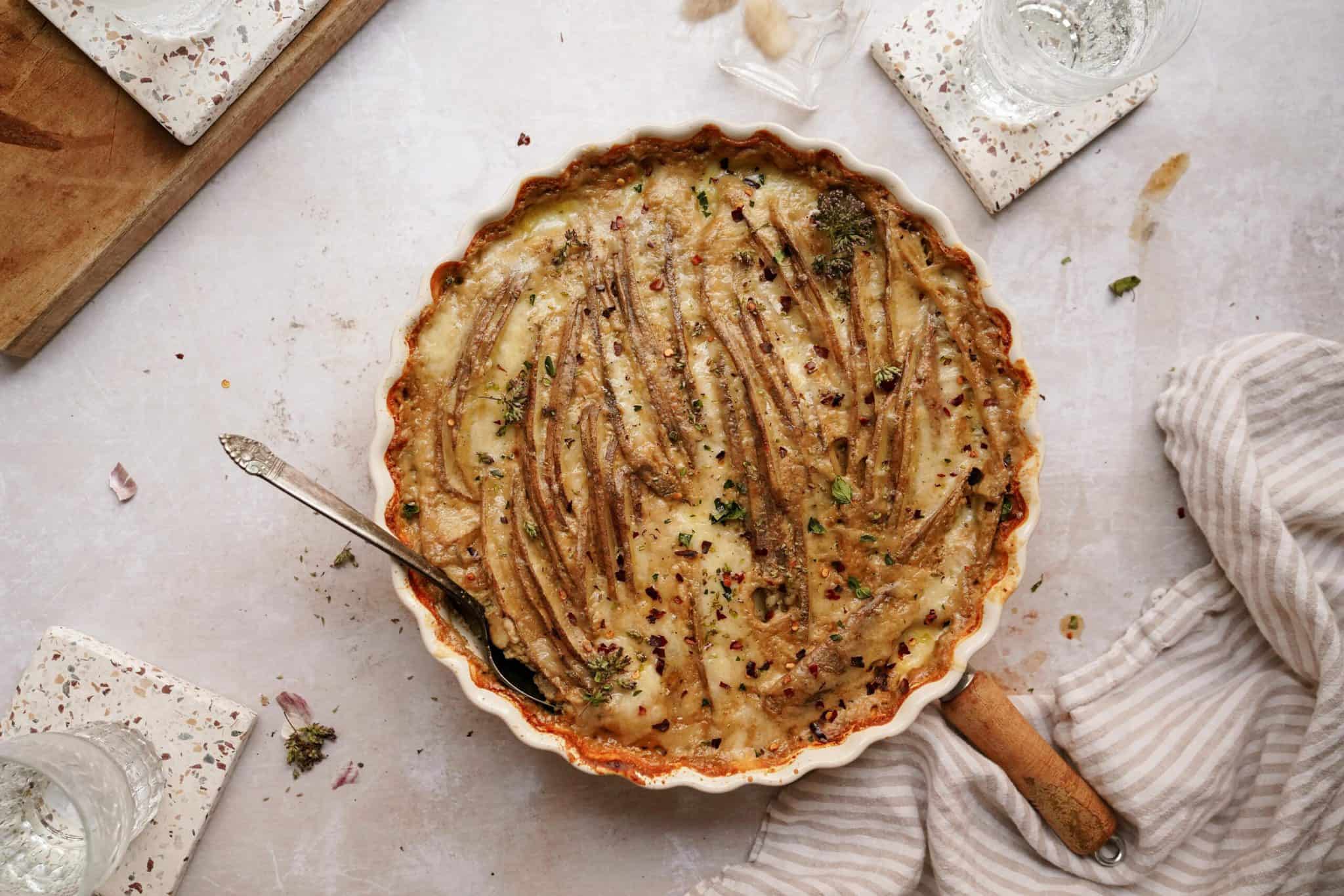 The best scalloped potatoes recipe in a casserole dish on a counter