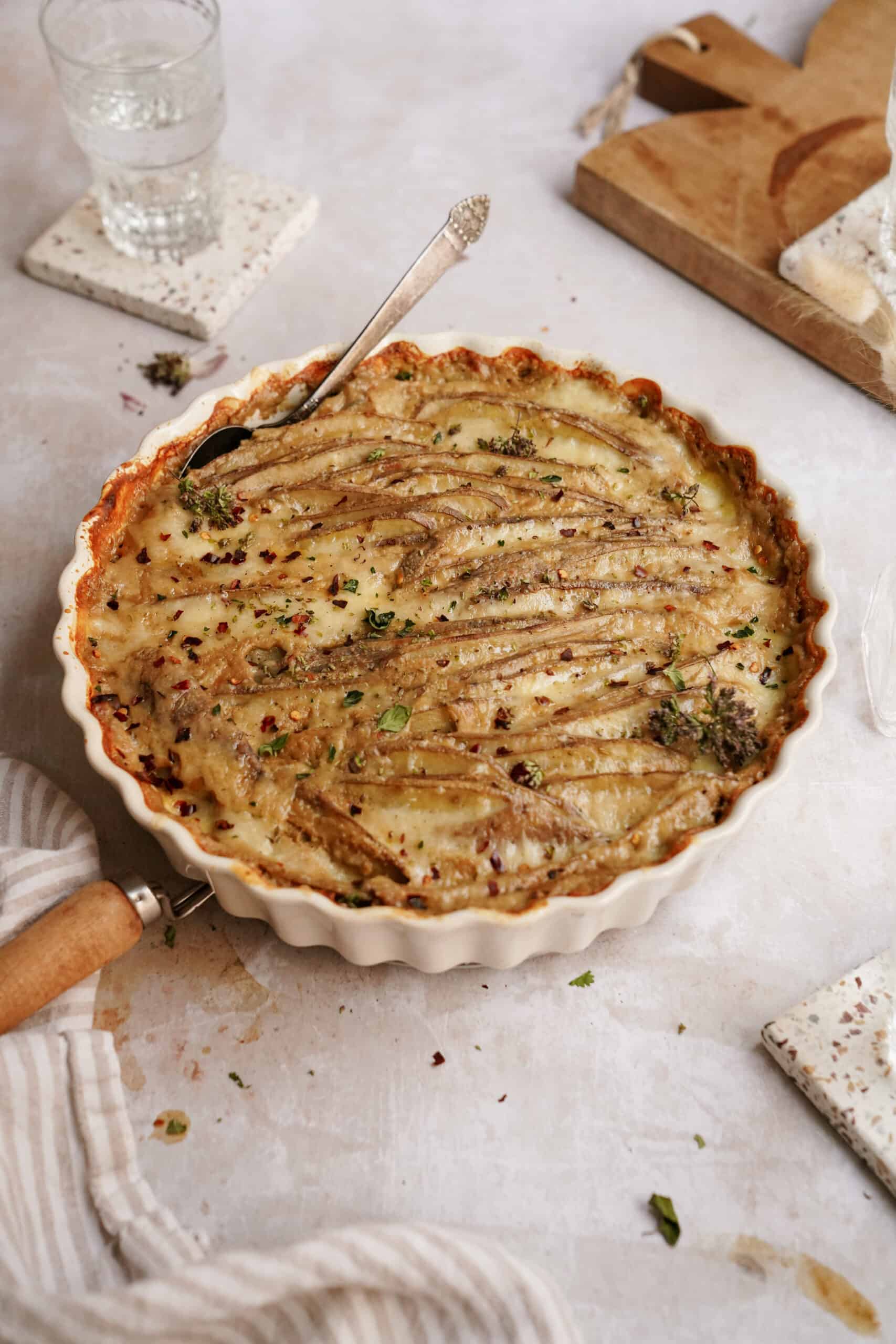 The best scalloped potatoes recipe in a casserole dish on a counter