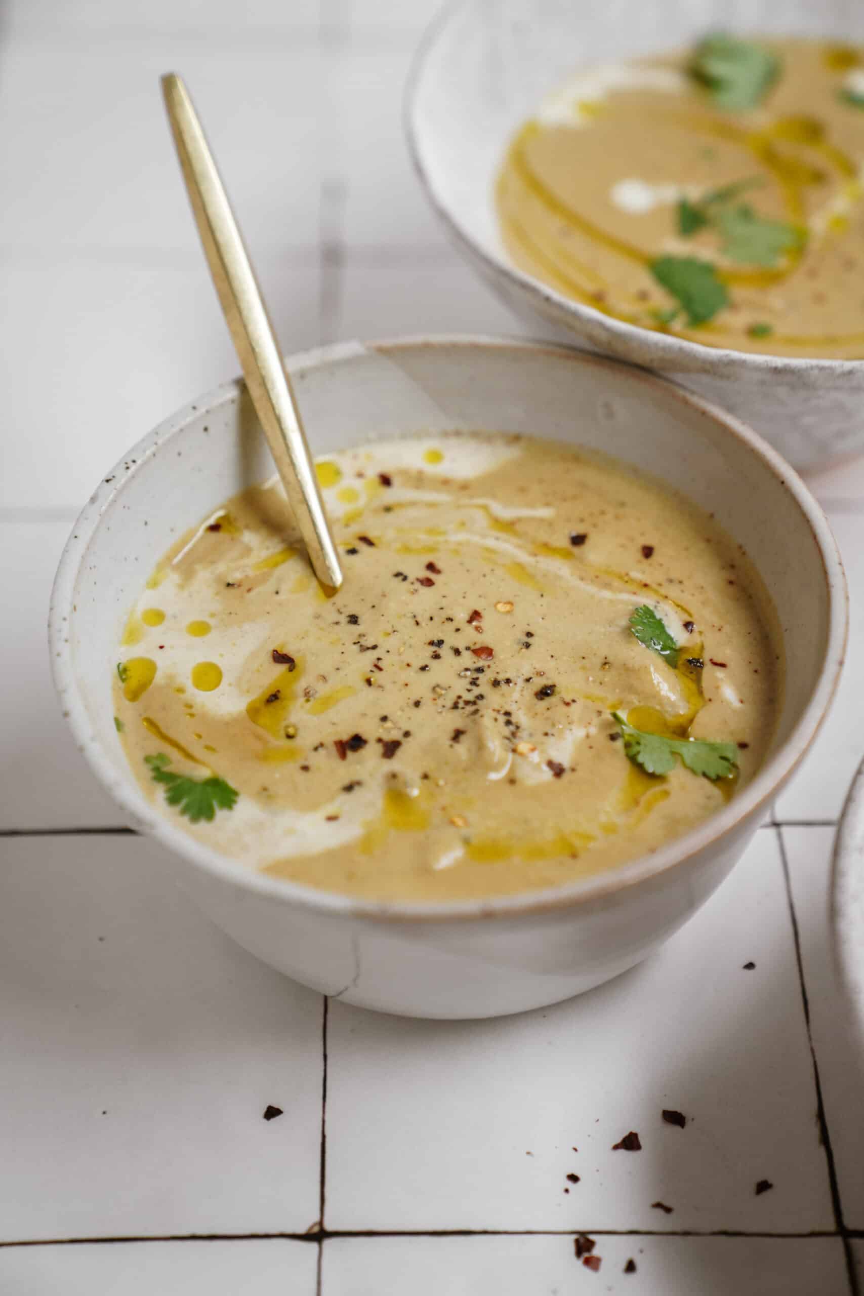 Broccoli Cauliflower Soup in a bowl on a counter