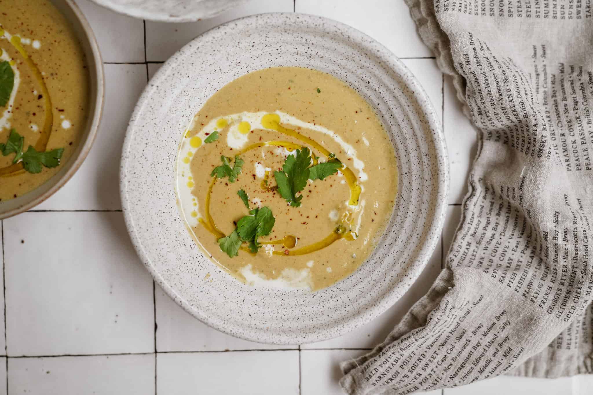 Broccoli Cauliflower Soup in a bowl on a counter