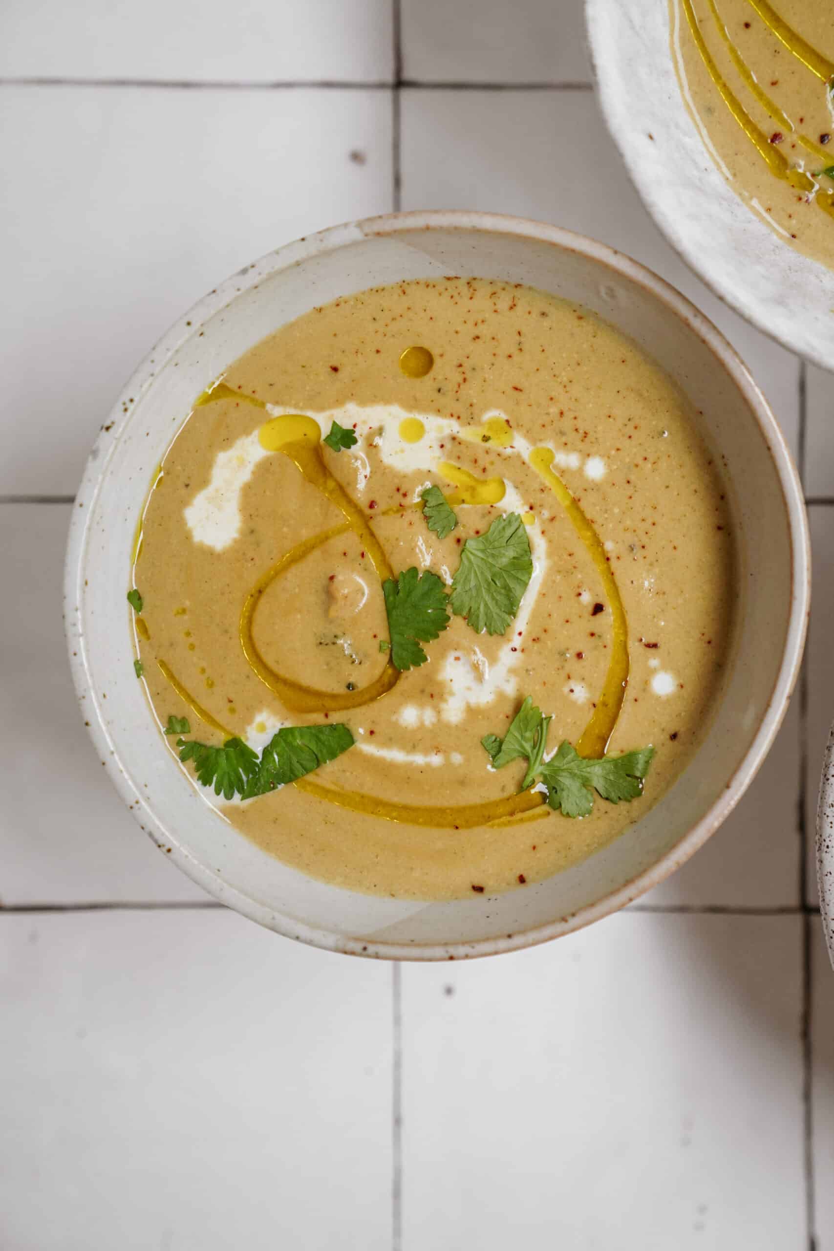 Broccoli Cauliflower Soup in a bowl on a counter