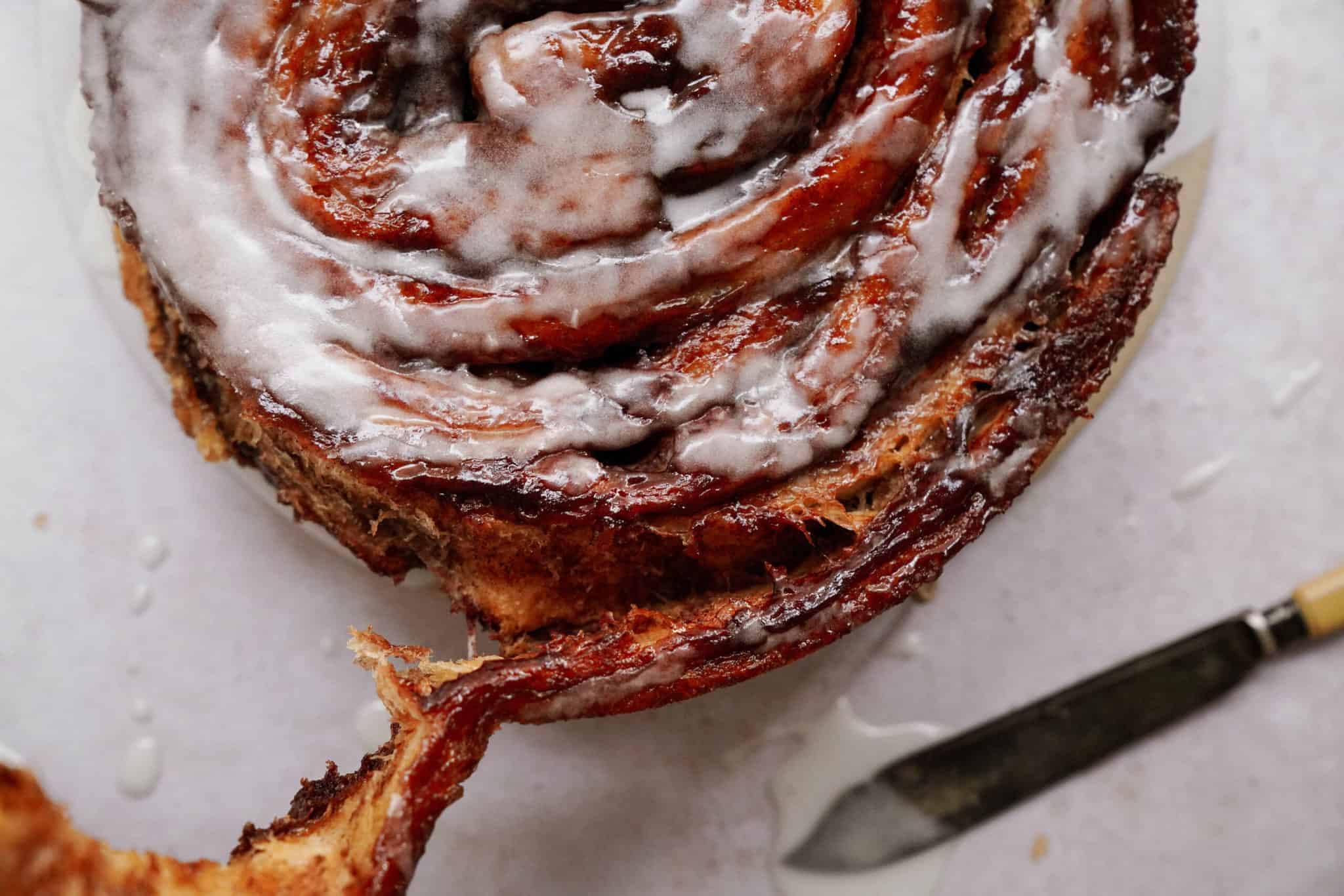 Peeling off a piece of a giant cinnamon roll