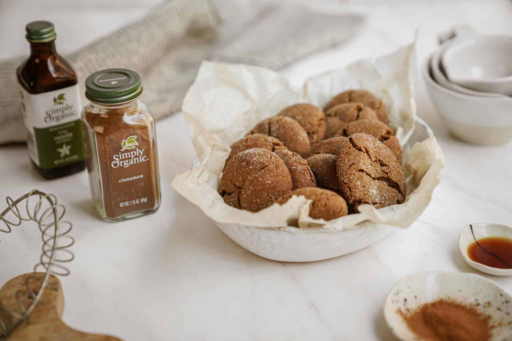 Ginger Snap Crinkle Cookies in a basket next to spices