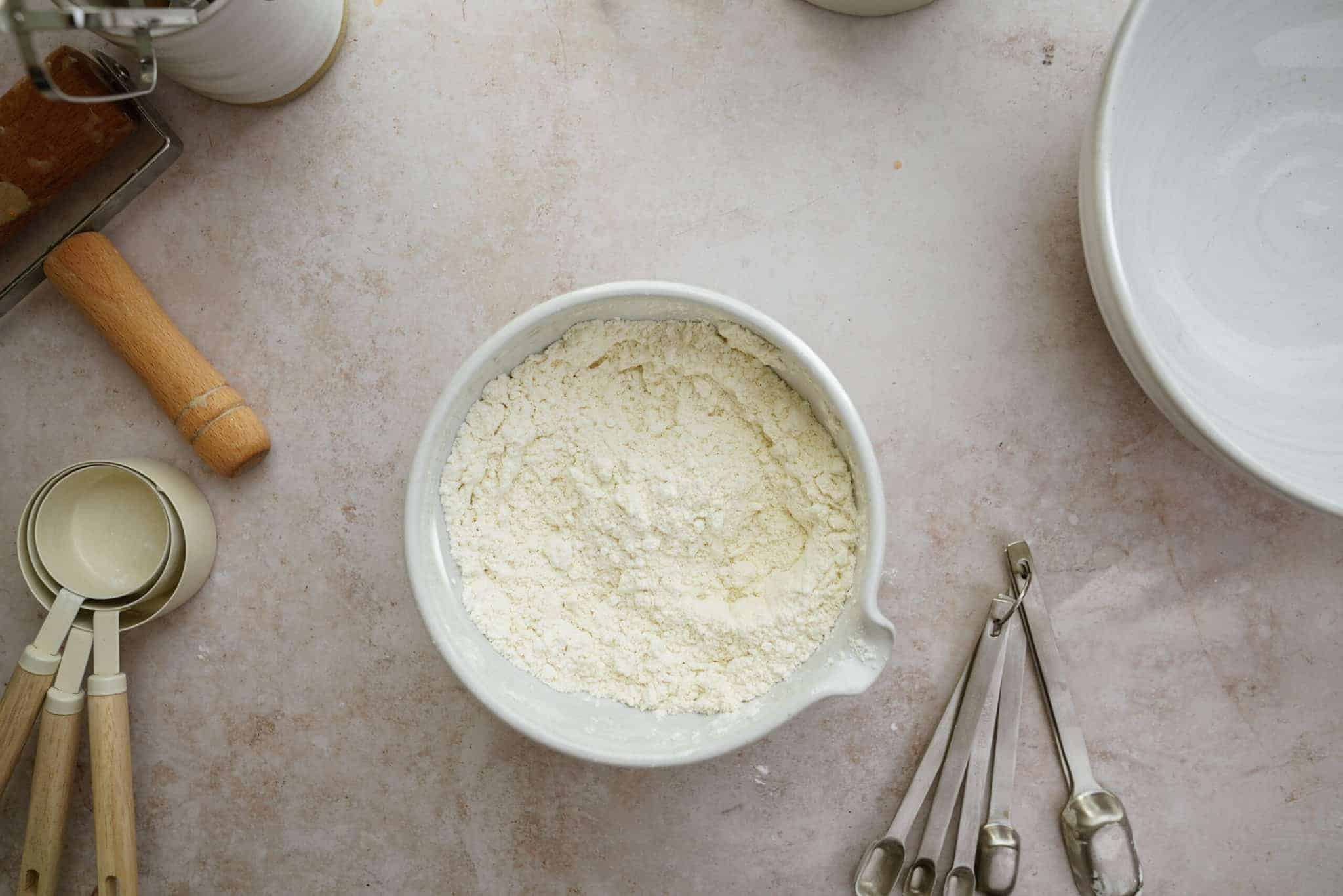 Dry ingredients for holiday sugar cookies on counter