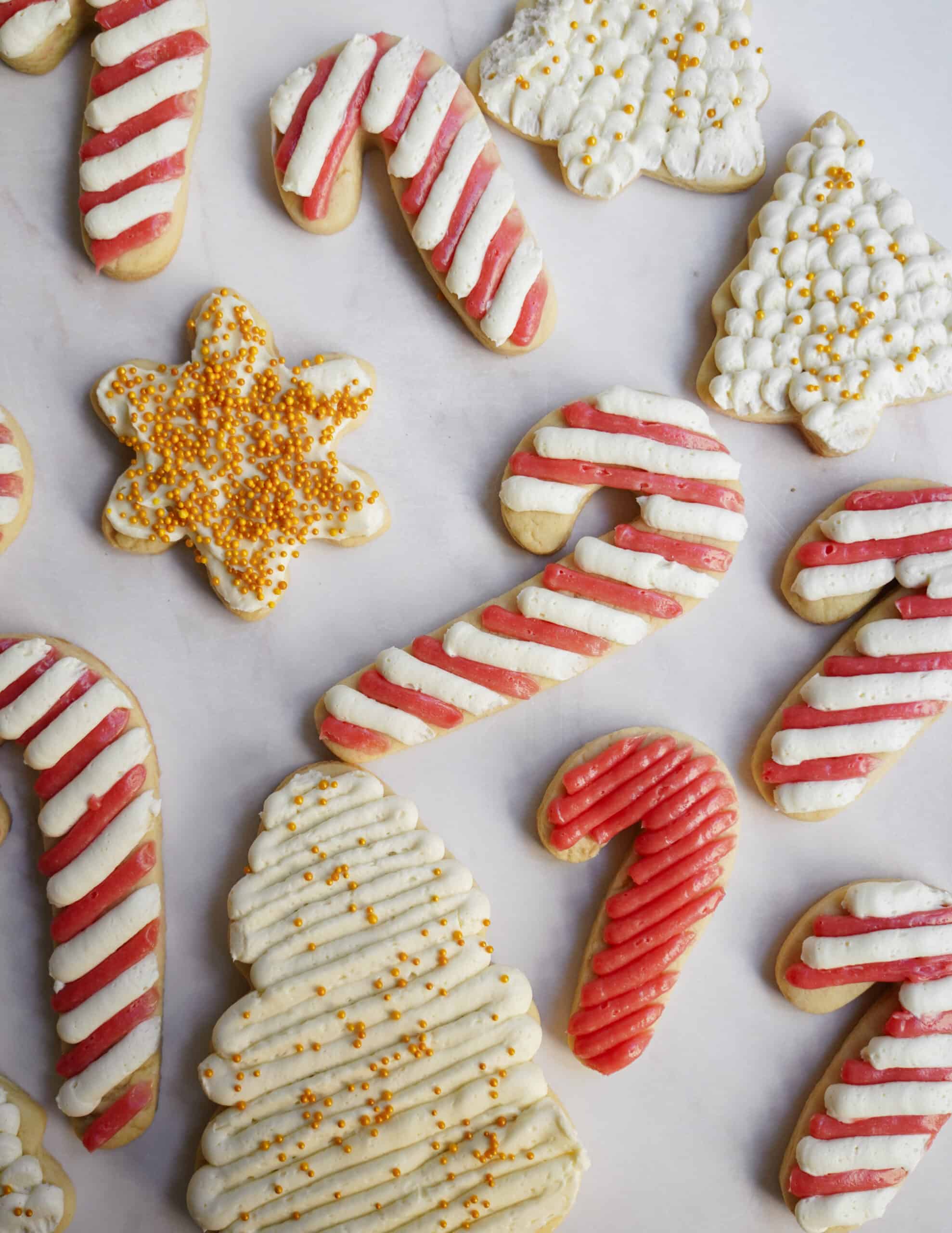 Holiday sugar cookies cut into fun shapes and scattered on counter