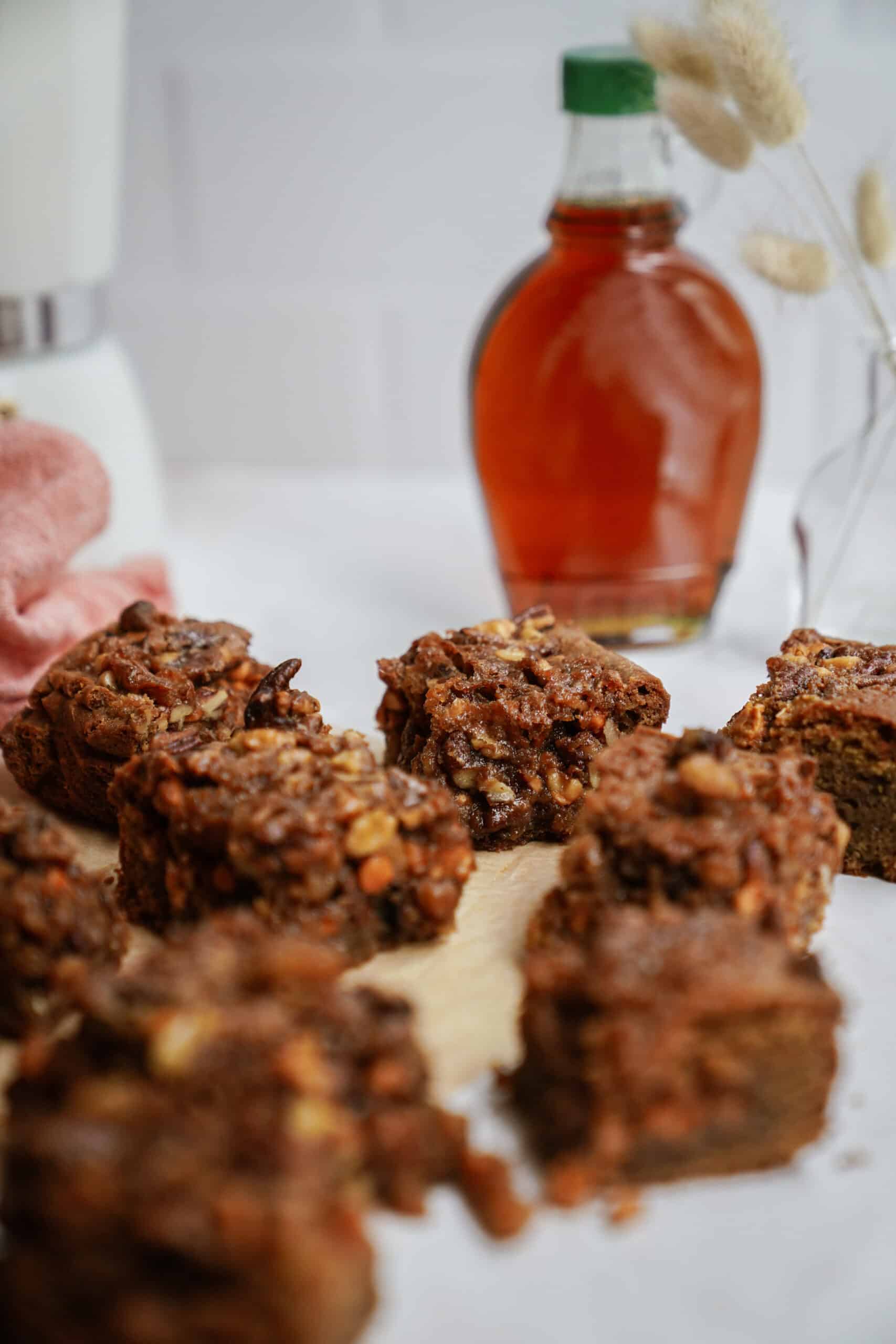 Maple bars on counter with maple syrup in the background