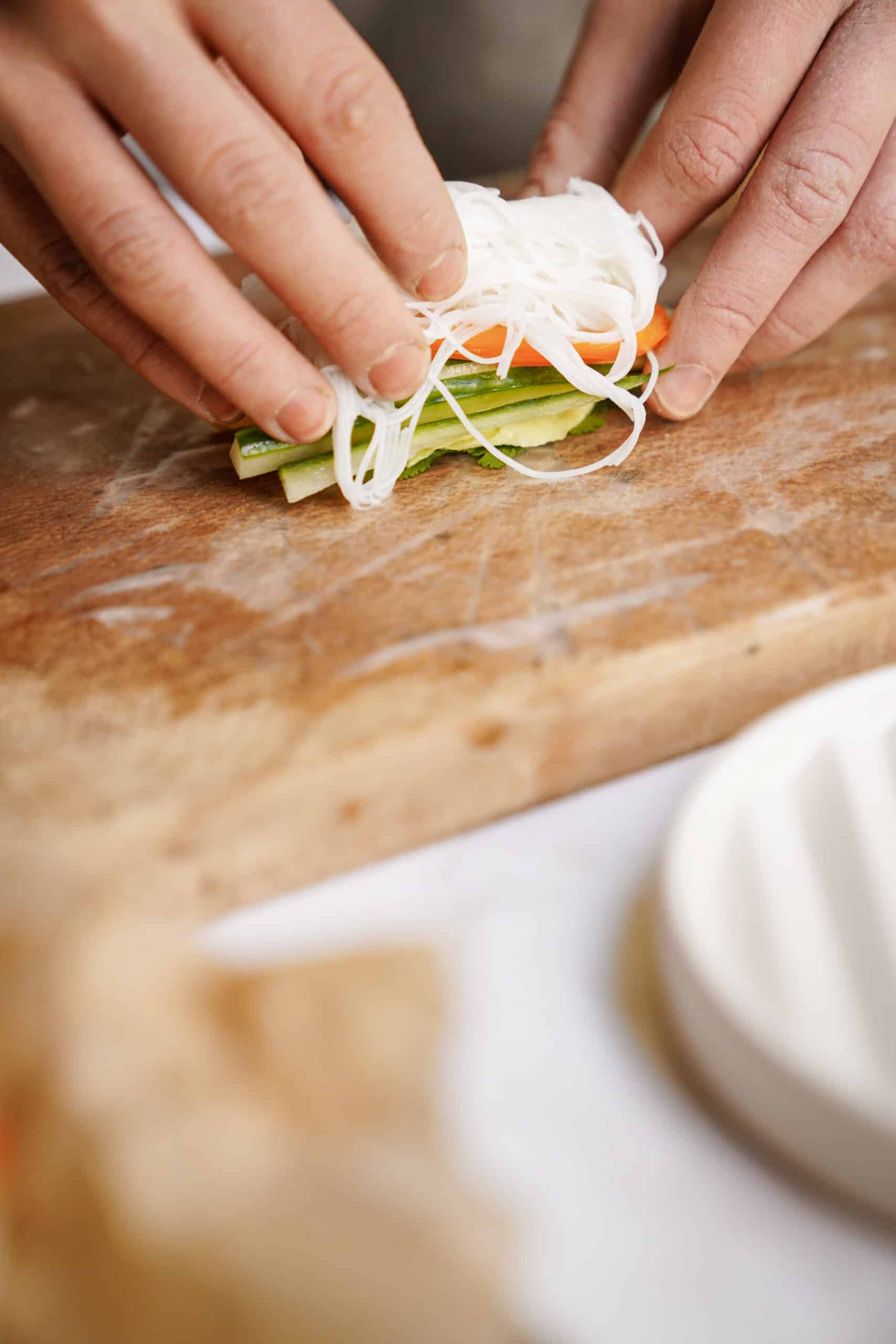 Stacking noodles on top of fresh veggies