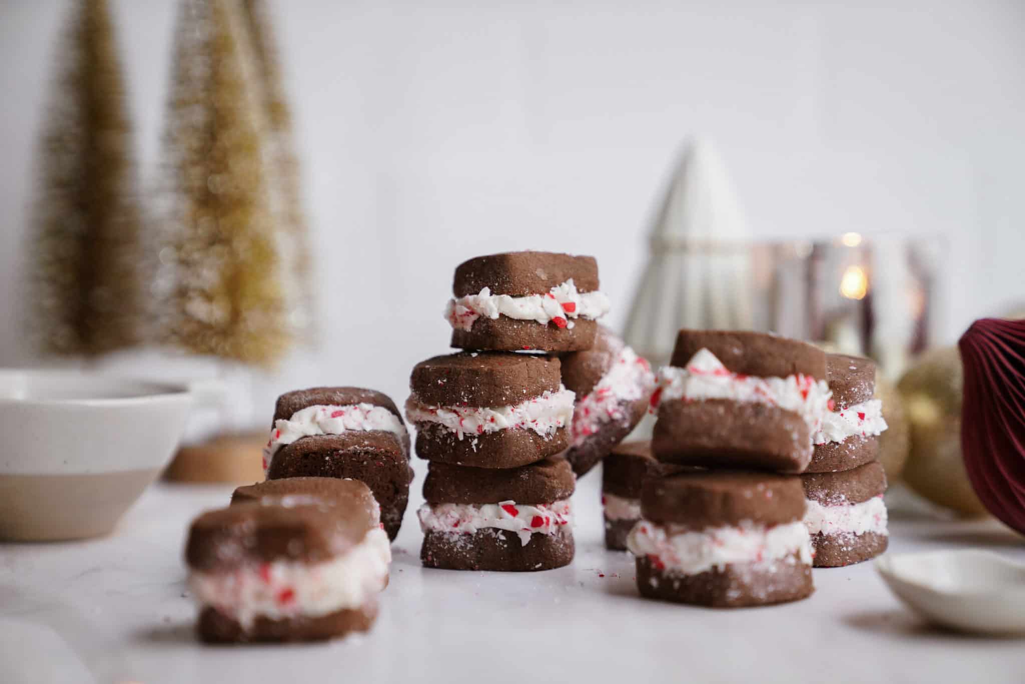 sandwich cookies stacked on a tabletop - one of the best gluten-free christmas cookie recipes