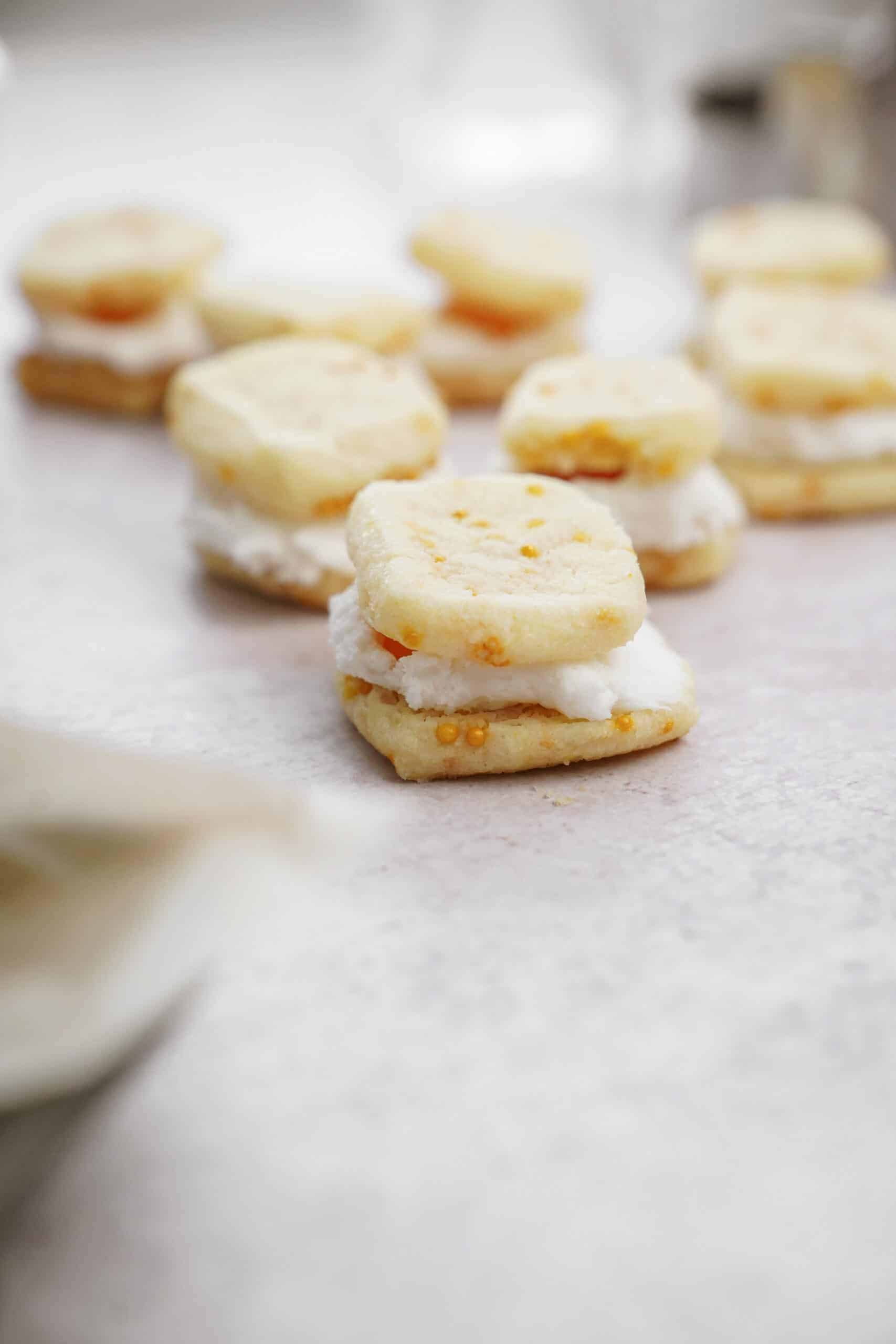 Holiday Shortbread Bites stuffed with vanilla icing on counter