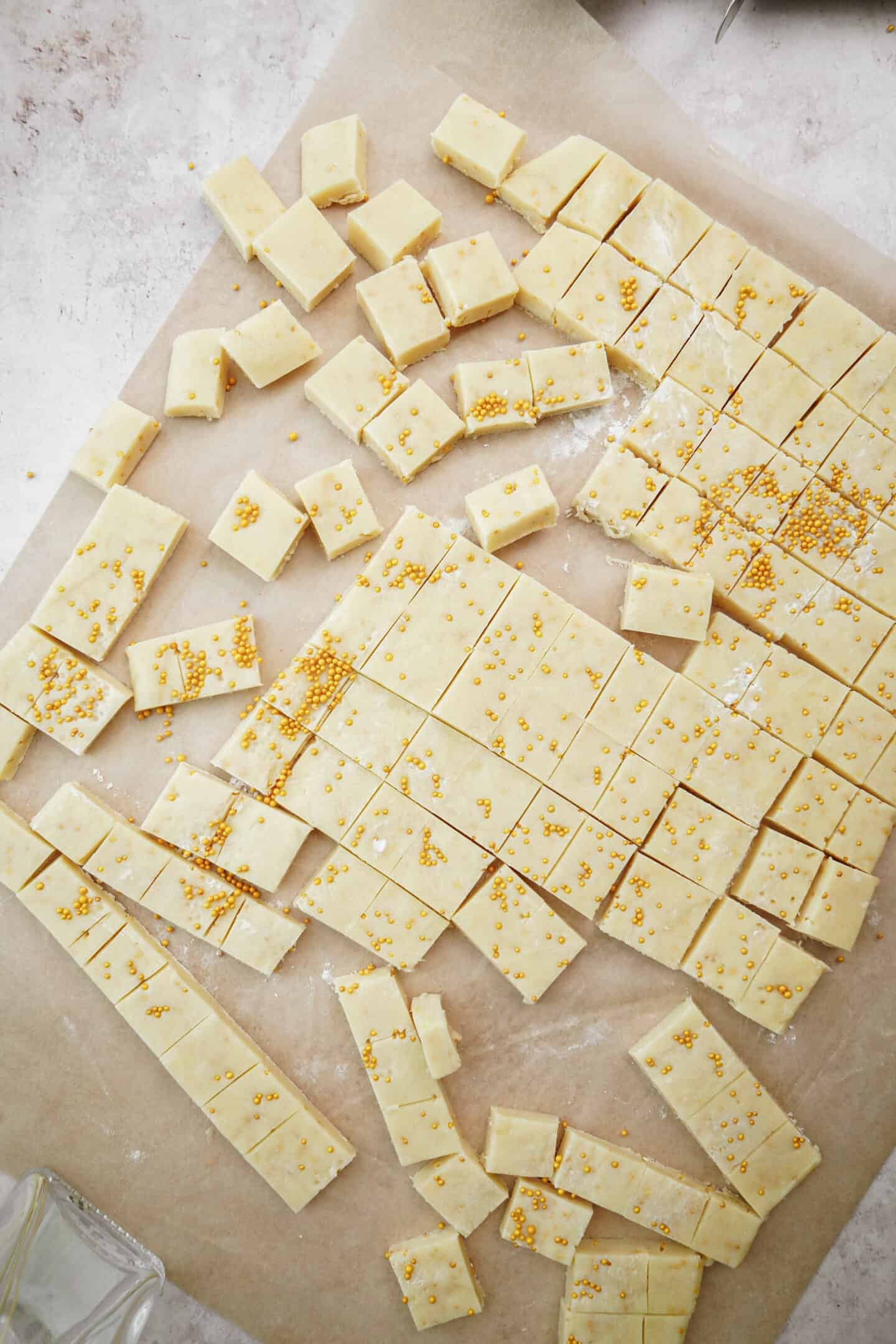 Holiday Shortbread Bites cut into squares on parchmant