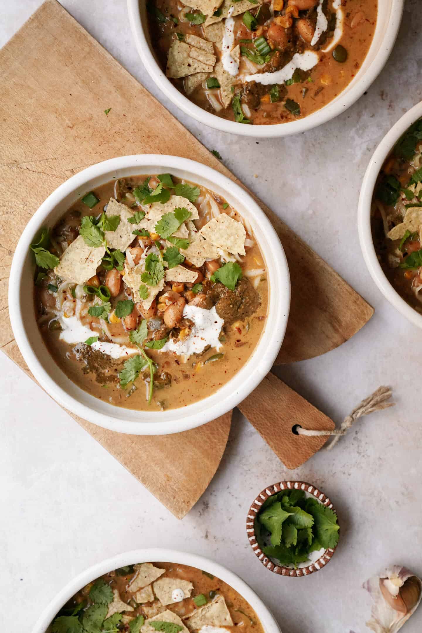 Bowl of tortilla soup on a cutting board