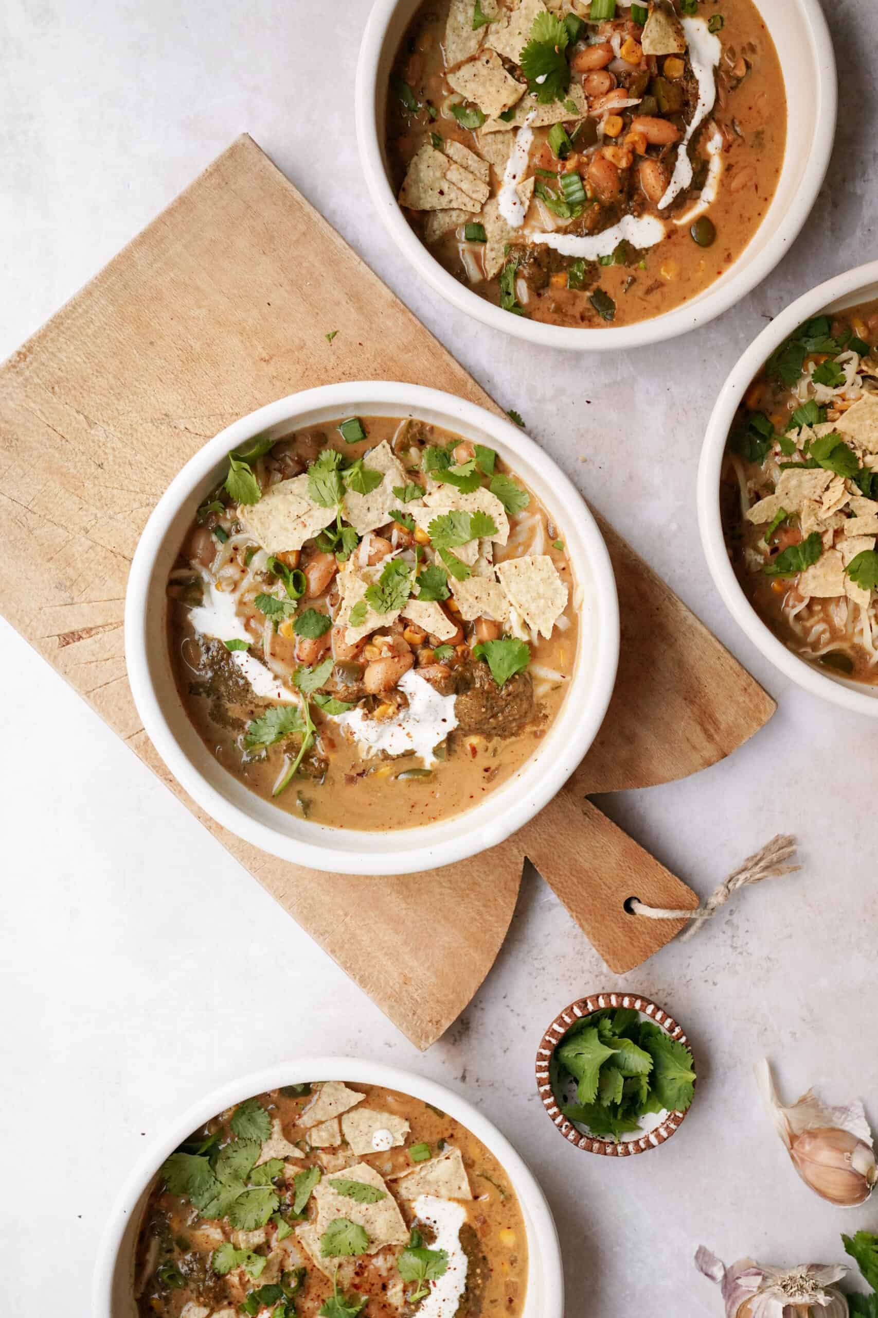 Tortilla soup recipe in serving bowls on a cutting board