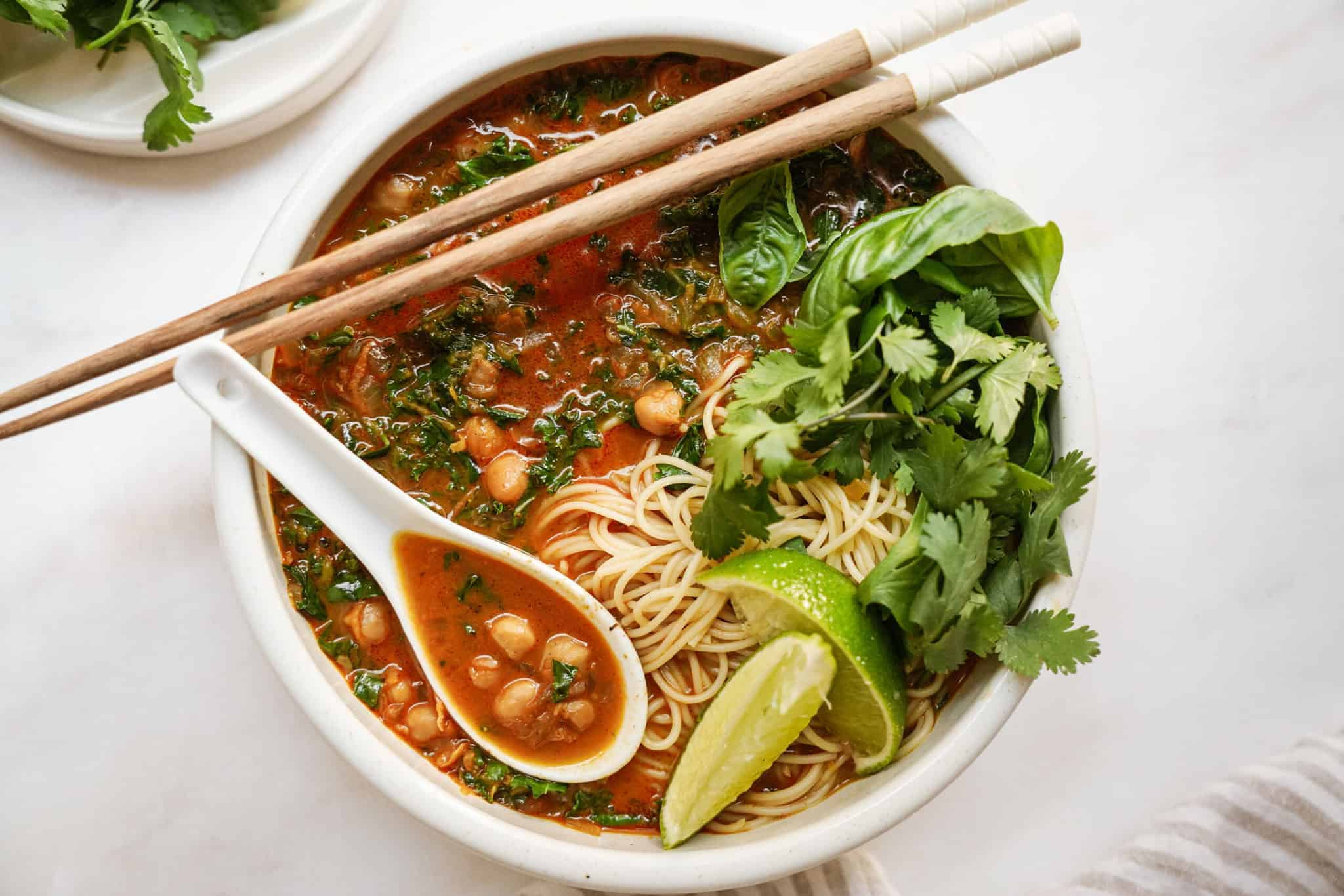 Curry noodle soup in big bowl with chopsticks