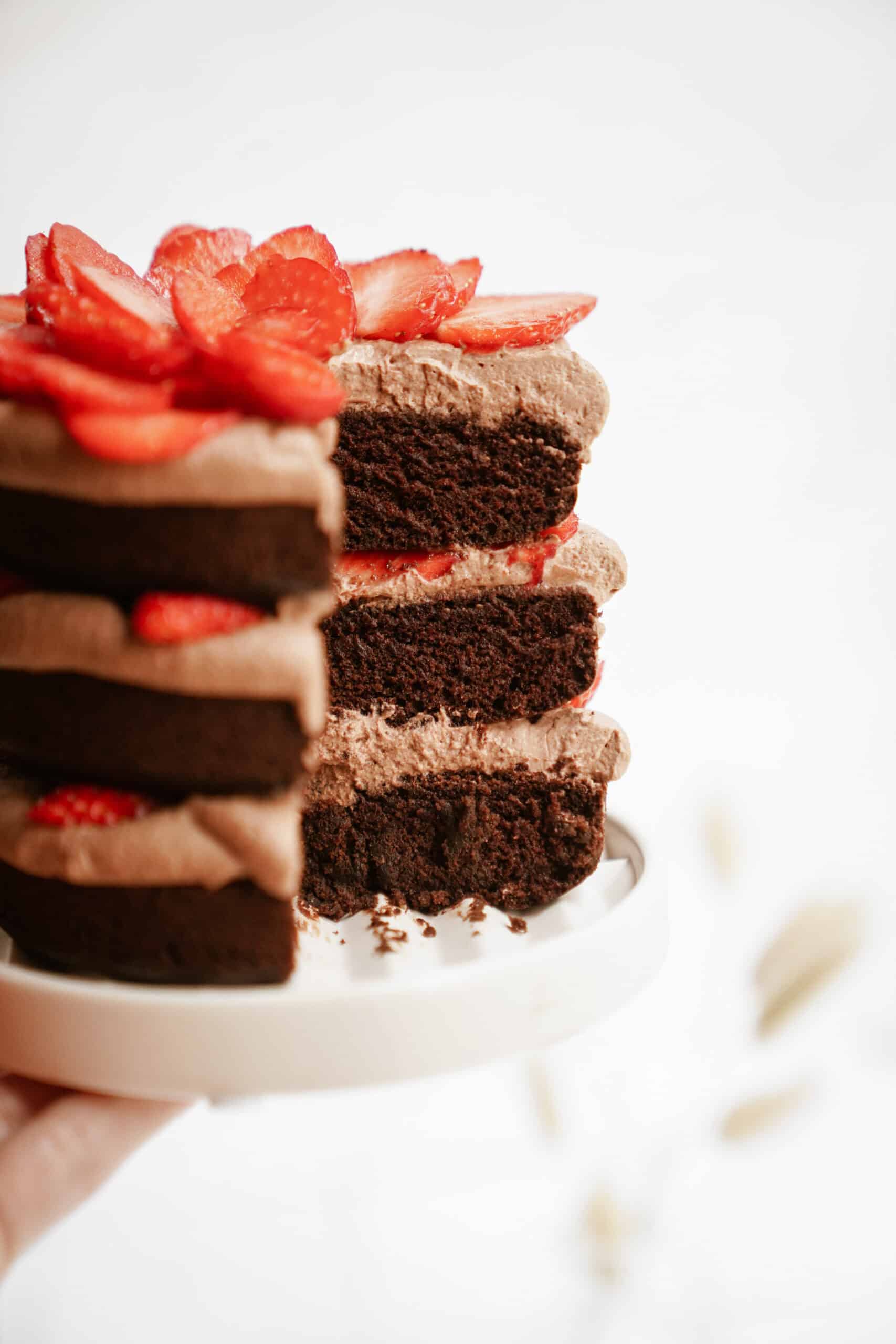 Gluten-free chocolate cake on a plate with a slice out of it