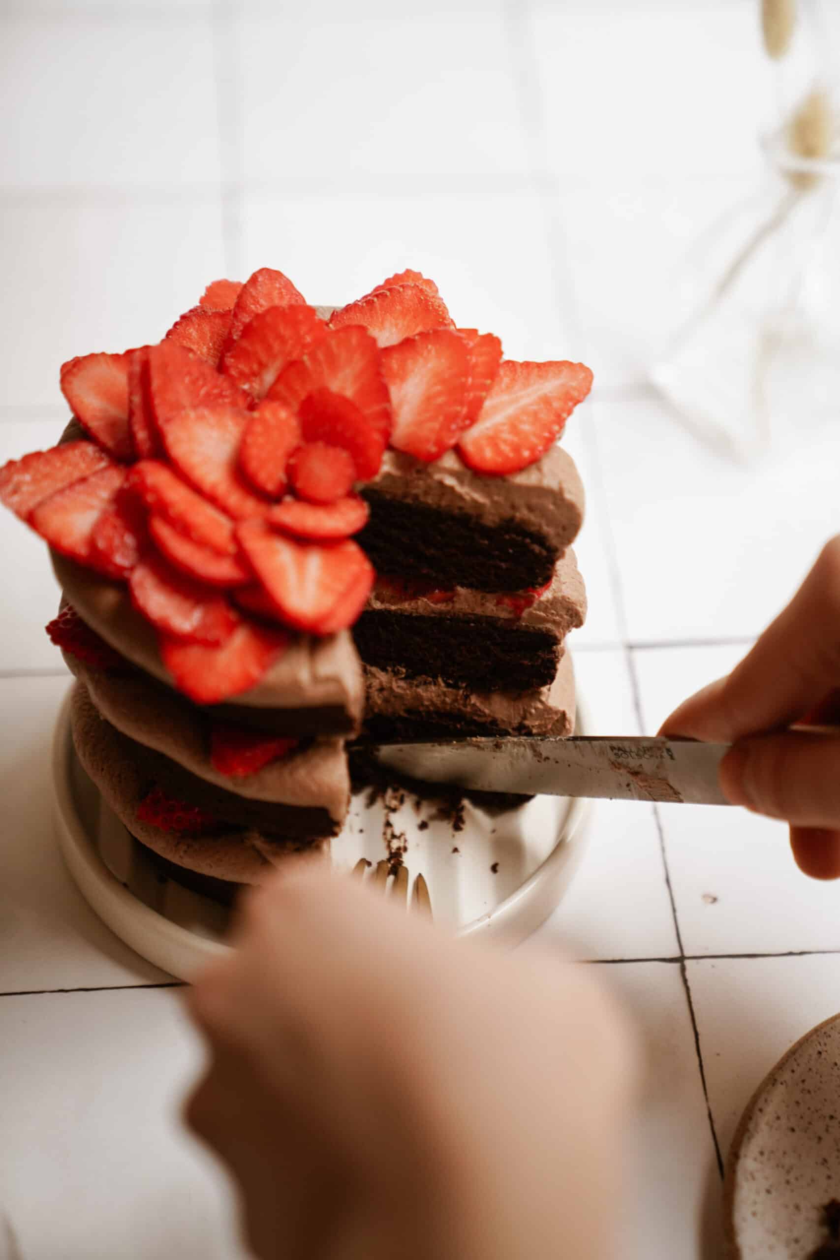 Gluten-free chocolate cake on a plate with a slice out of it