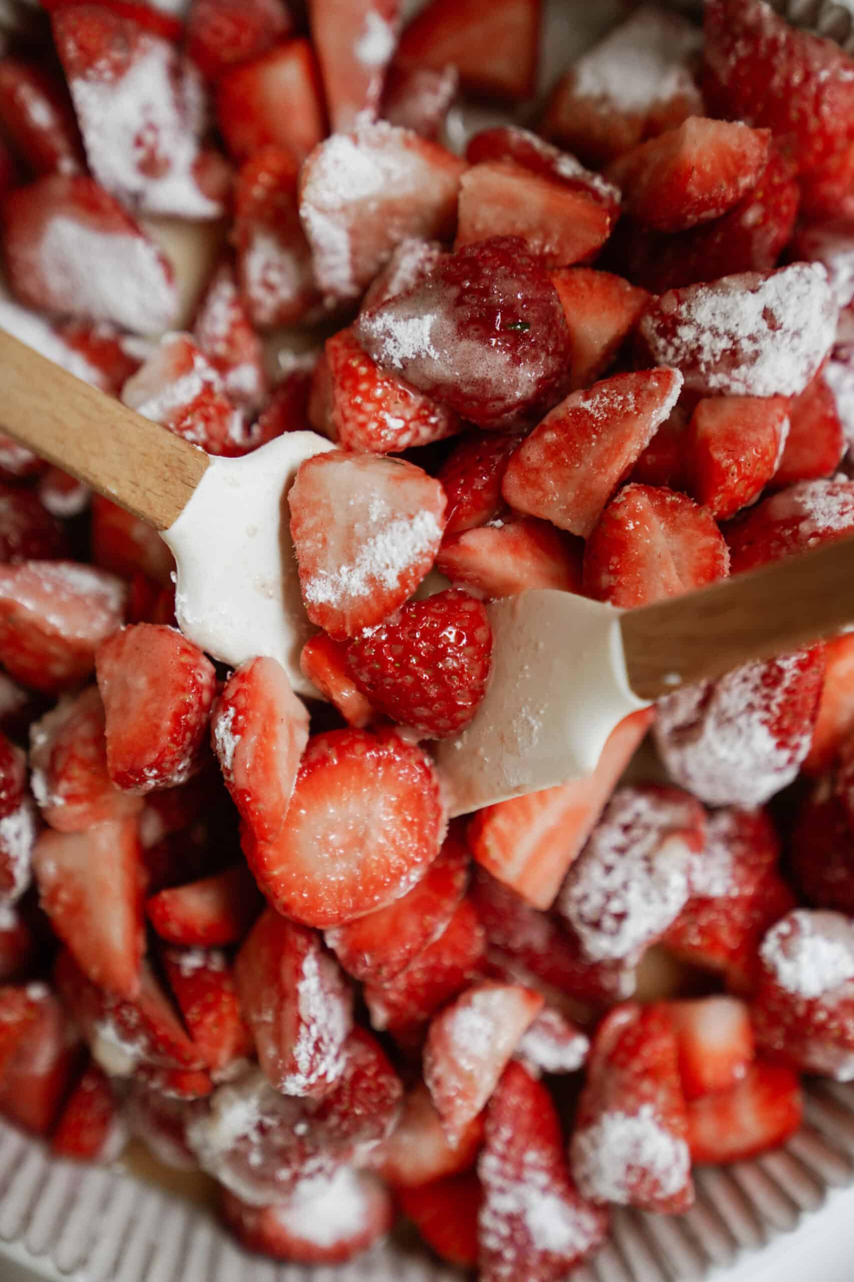 Tossing strawberries for strawberry crumble together
