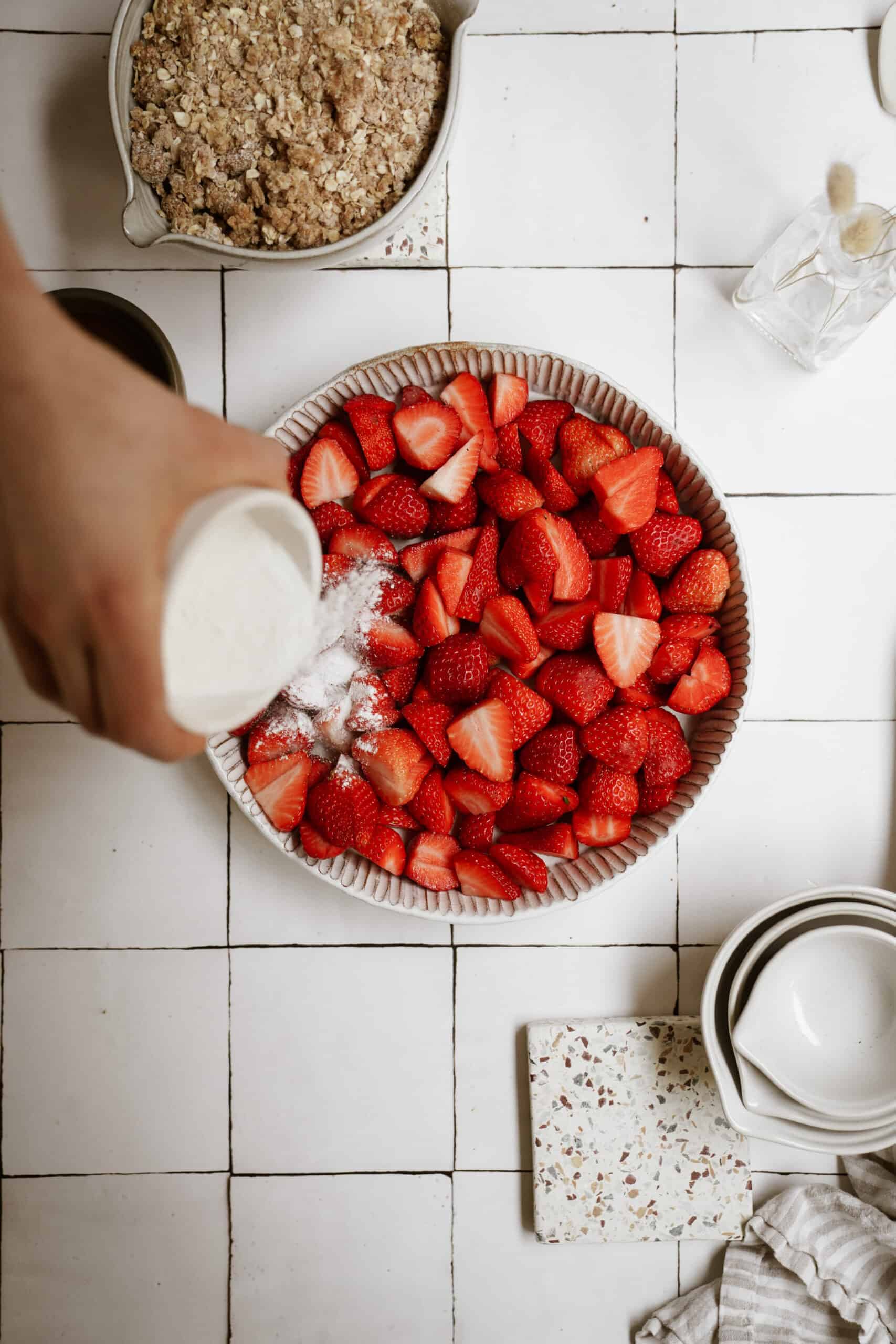 Ingredients being poured on top of strawberries