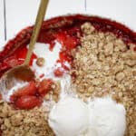 Close-up of strawberry crumble with vanilla ice cream on top