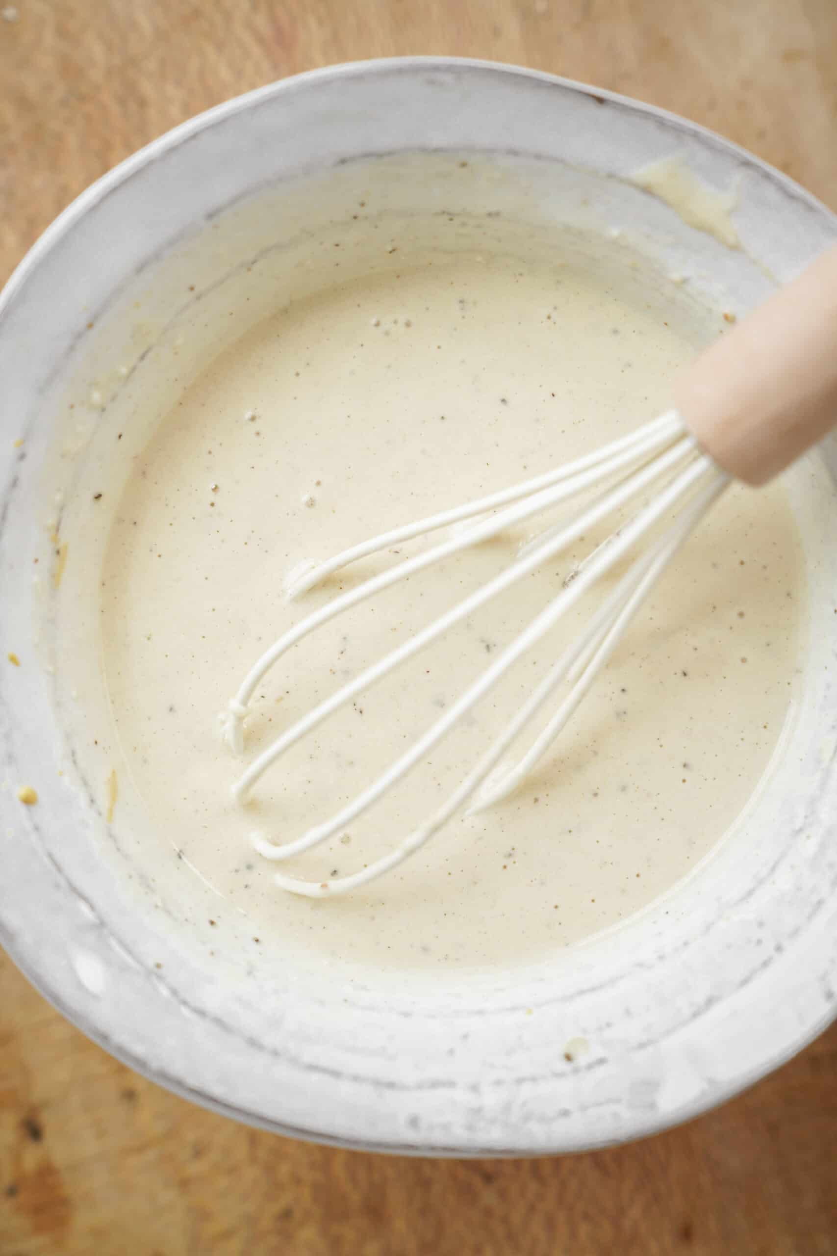Caesar salad dressing recipe whisked in a bowl