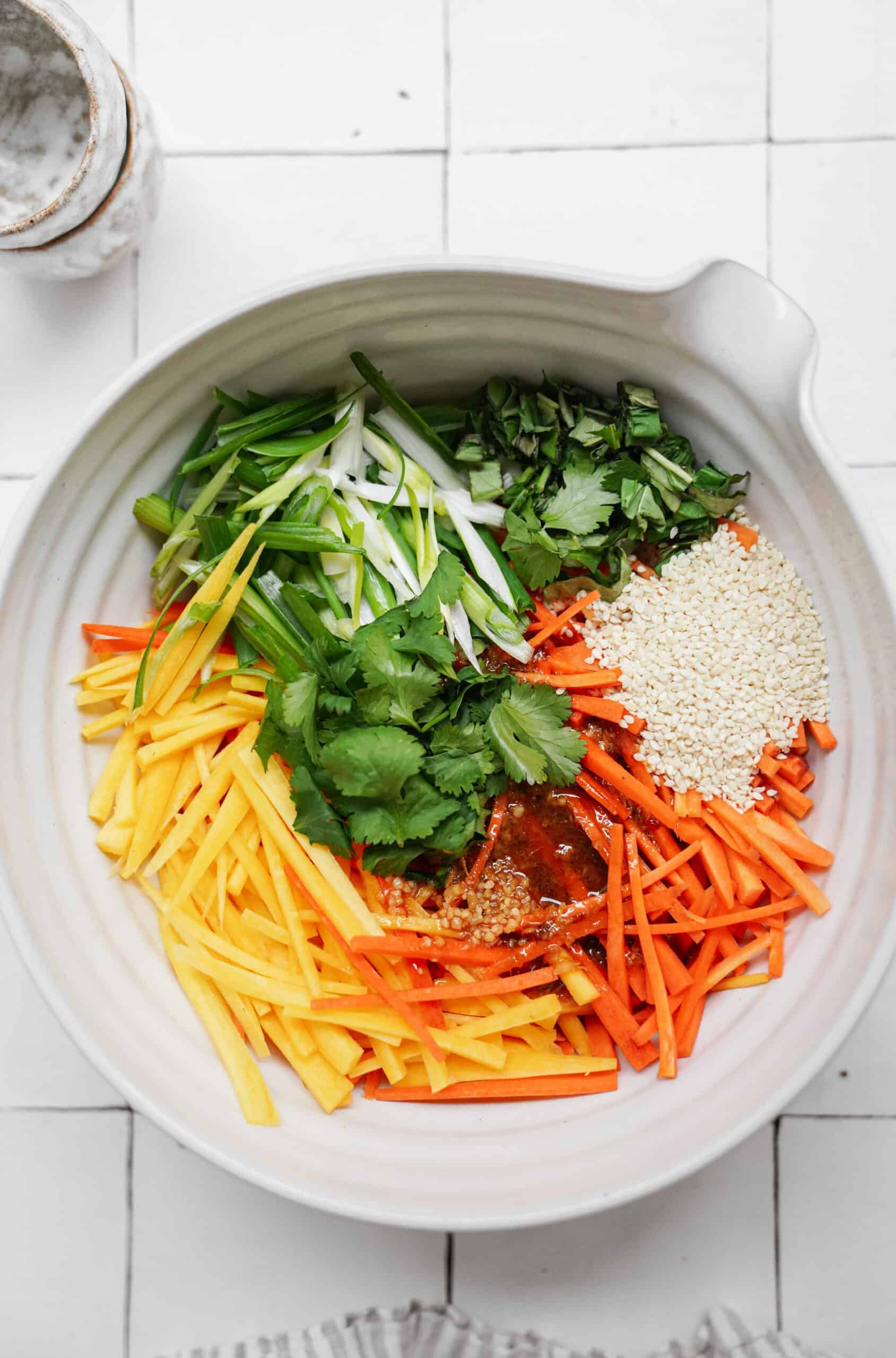 Fresh ingredients for carrot salad in a bowl
