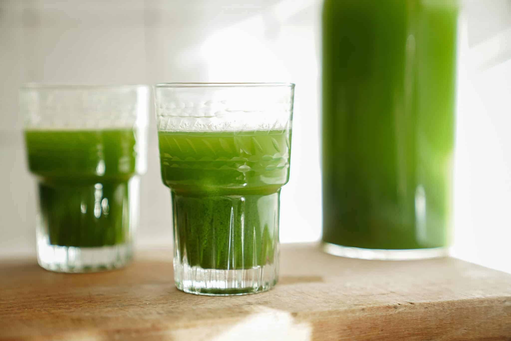 Green juice recipe in 2 glasses on a counter