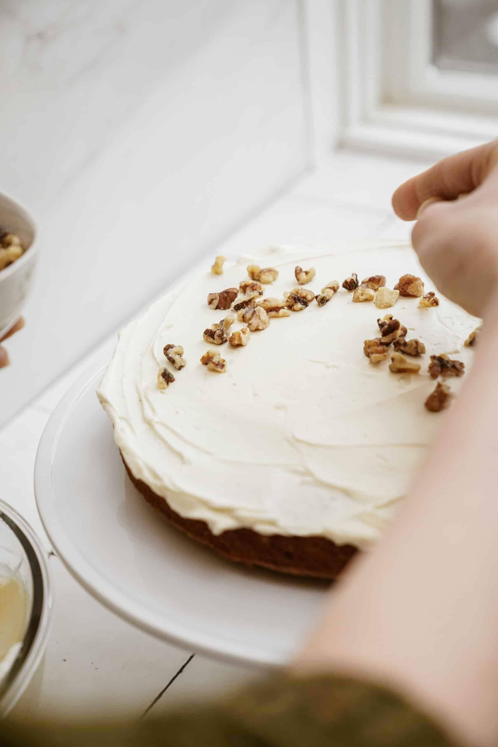 placing walnuts on carrot cake