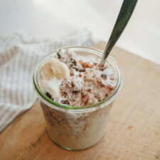 Overnight oats in a jar with a spoon in them