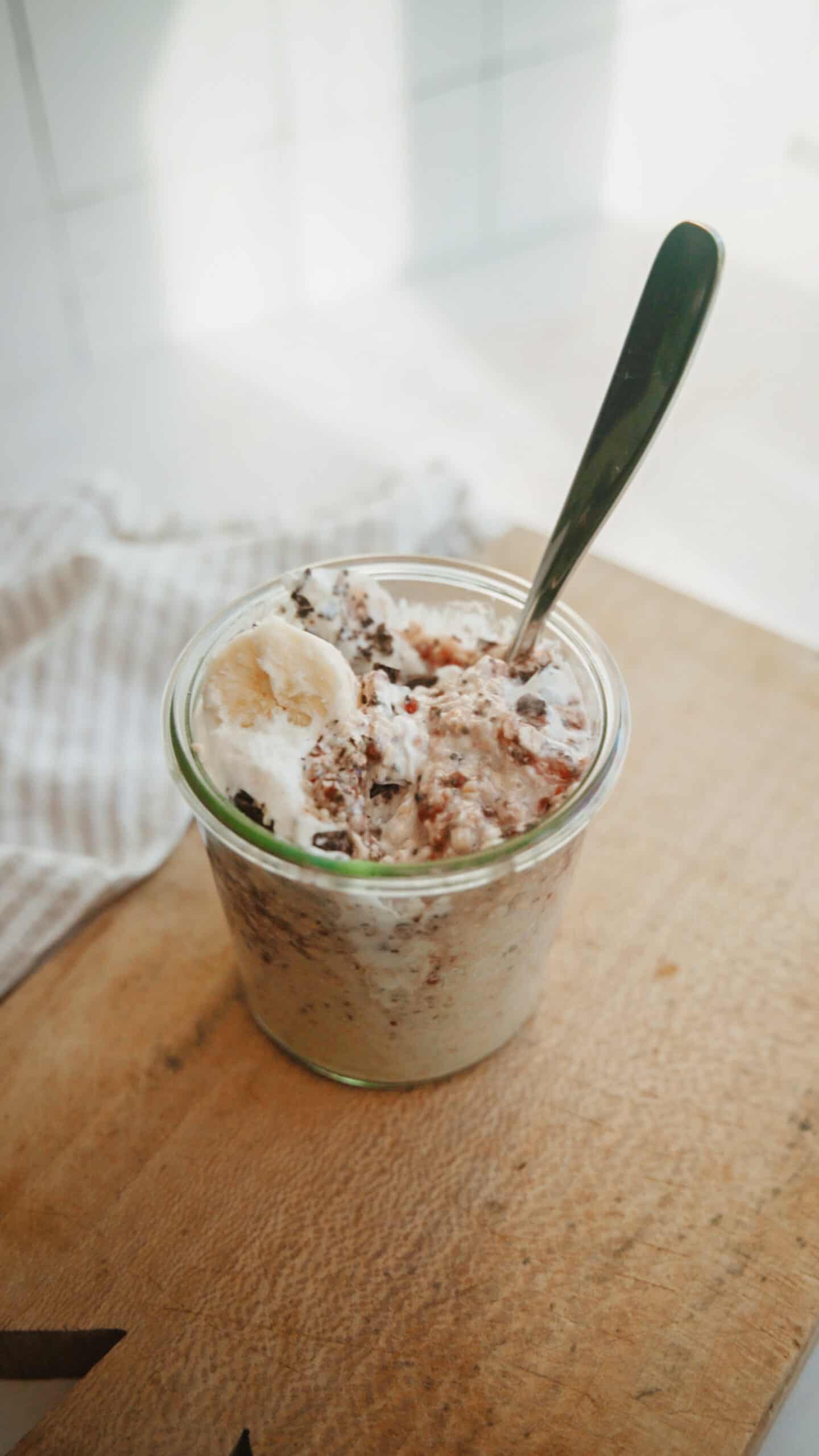 Overnight oats in a jar with a spoon in them