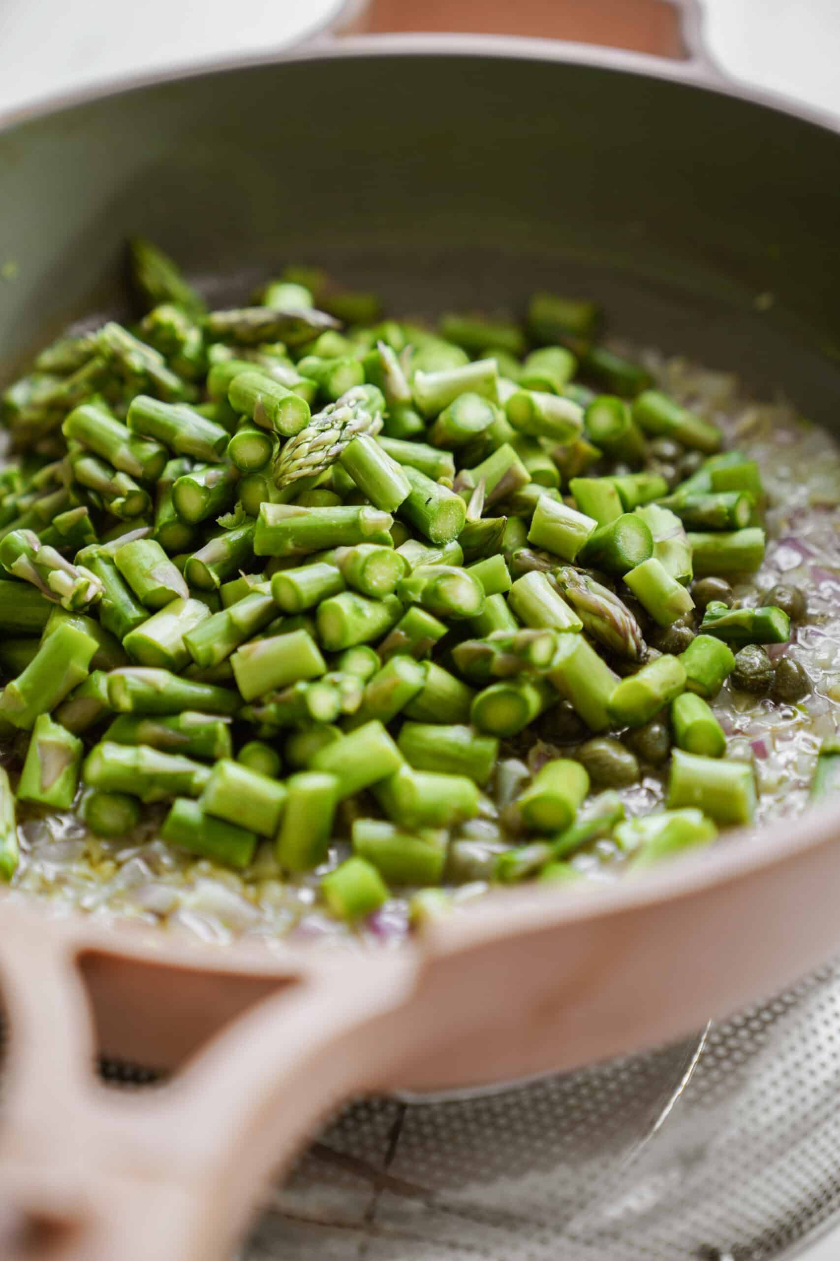 Fresh asparagus in a frying pan