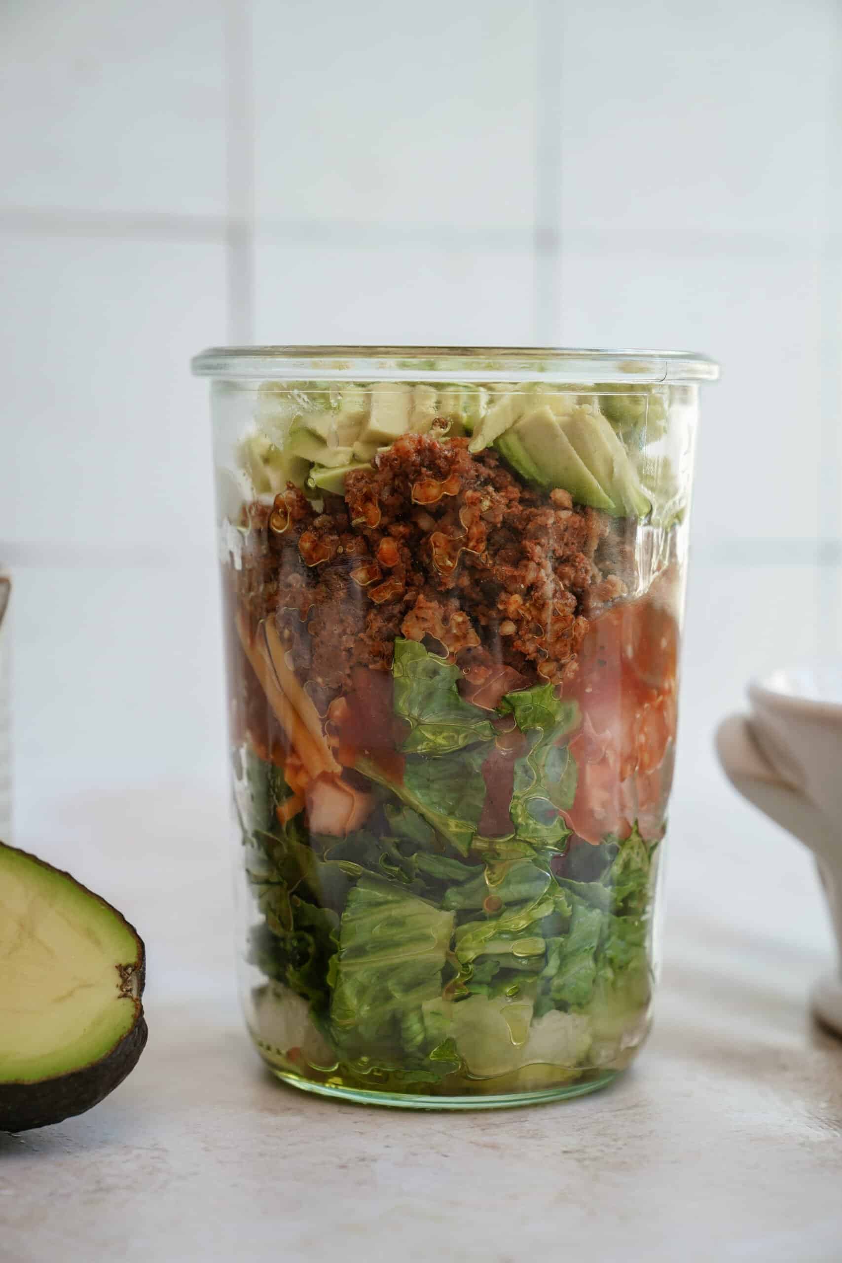Taco salad on counter top in a mason jar